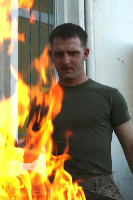 ANAH, Iraq ? Cpl. Matthew Magnuson the combat cook from Company K, 3rd Battalion, 2nd Marine Regiment, Task Force Wolfpack, Regimental Combat Team 2, fires up the grill to prepare for evening chow at Camp Ocotal, Anah, Iraq. As the only combat cook for Company K, Magnuson serves up to 250 Marines, soldiers and sailors.