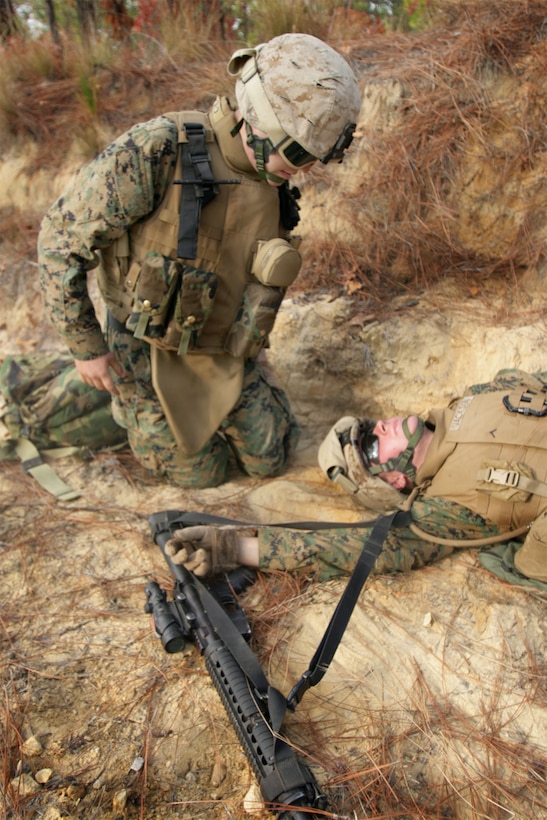 FORT BRAGG, N.C. ?Seaman Brian Andrade, a hospital corpsman with 1st Battalion, 2nd Marine Regiment, 2nd Marine Division, II Marine Expeditionary Force, treats a casualty during a counter improvised explosive device operations exercise here Dec. 9. The convoy was hit by a simulated IED as part of a 10-day urban training exercise to prepare for an upcoming deployment in support of Operation Iraqi Freedom.