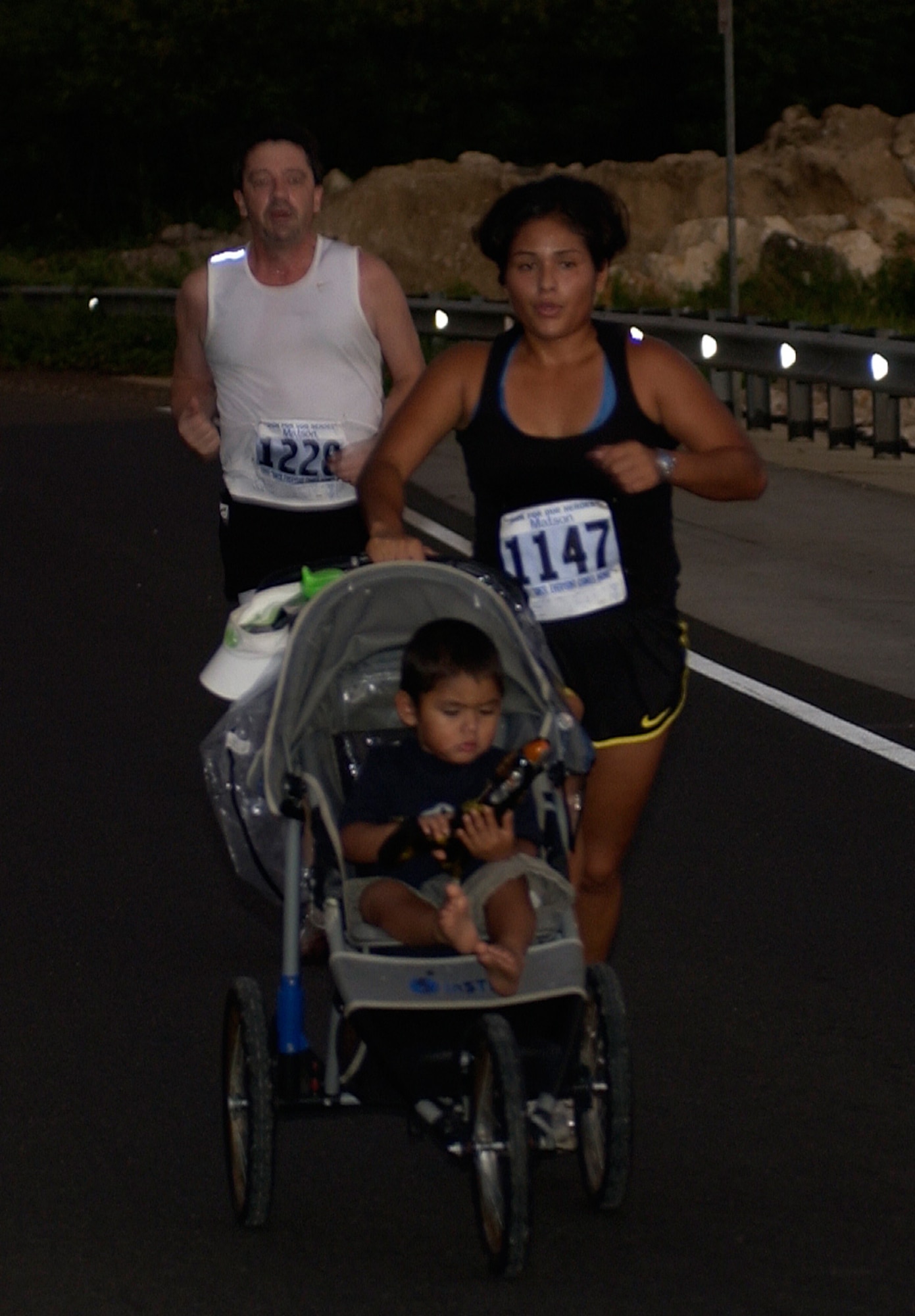 Rachel Meza, wife of Jose Meza III, 36th Security Forces Squadron, runs with her son during the 2007 USO Run for Our Heroes 5K Run/Walk at the United Seamen's Service in Piti, Guam, Dec. 8. (U.S. Air Force photo/Senior Airman Angelique Smythe)