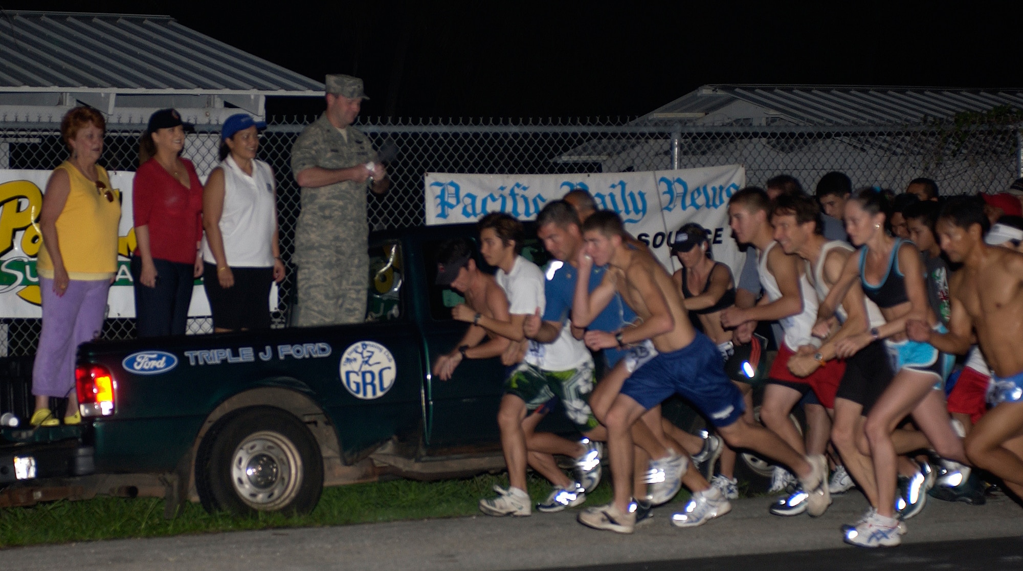 Brig. Gen. Doug Owens, 36th Wing commander, sounds the horn to begin the 2007 Run for Our Heroes 5K Run/Walk Dec. 8 at the United Seaman's Service in Piti, Guam. (U.S. Air Force photo/Senior Airman Angelique Smythe)