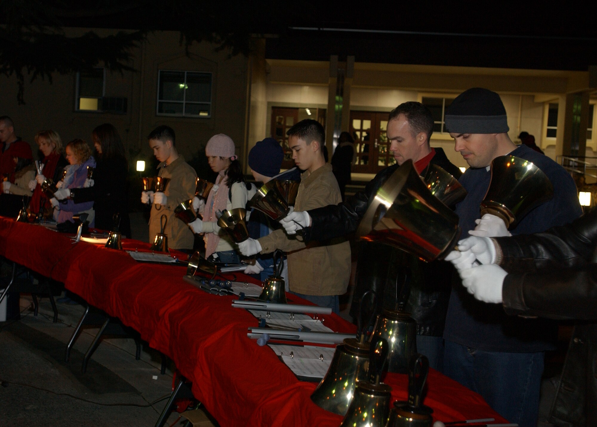 YOKOTA AIR BASE, Japan - The Yokota Hand Bell Choir performs Christmas songs during the Christmas Tree Lighting ceremony on December 6, 2007.  The ceremony included singing from the Yokota Community Choir, a visit from Santa Claus and the lighting of the Yokota Christmas tree by Colonel Jeff Newell, commander of the 374th Airlift Wing, and a number of children. (U.S. Air Force photo by Airman First Class Jonathan Fowler)                               