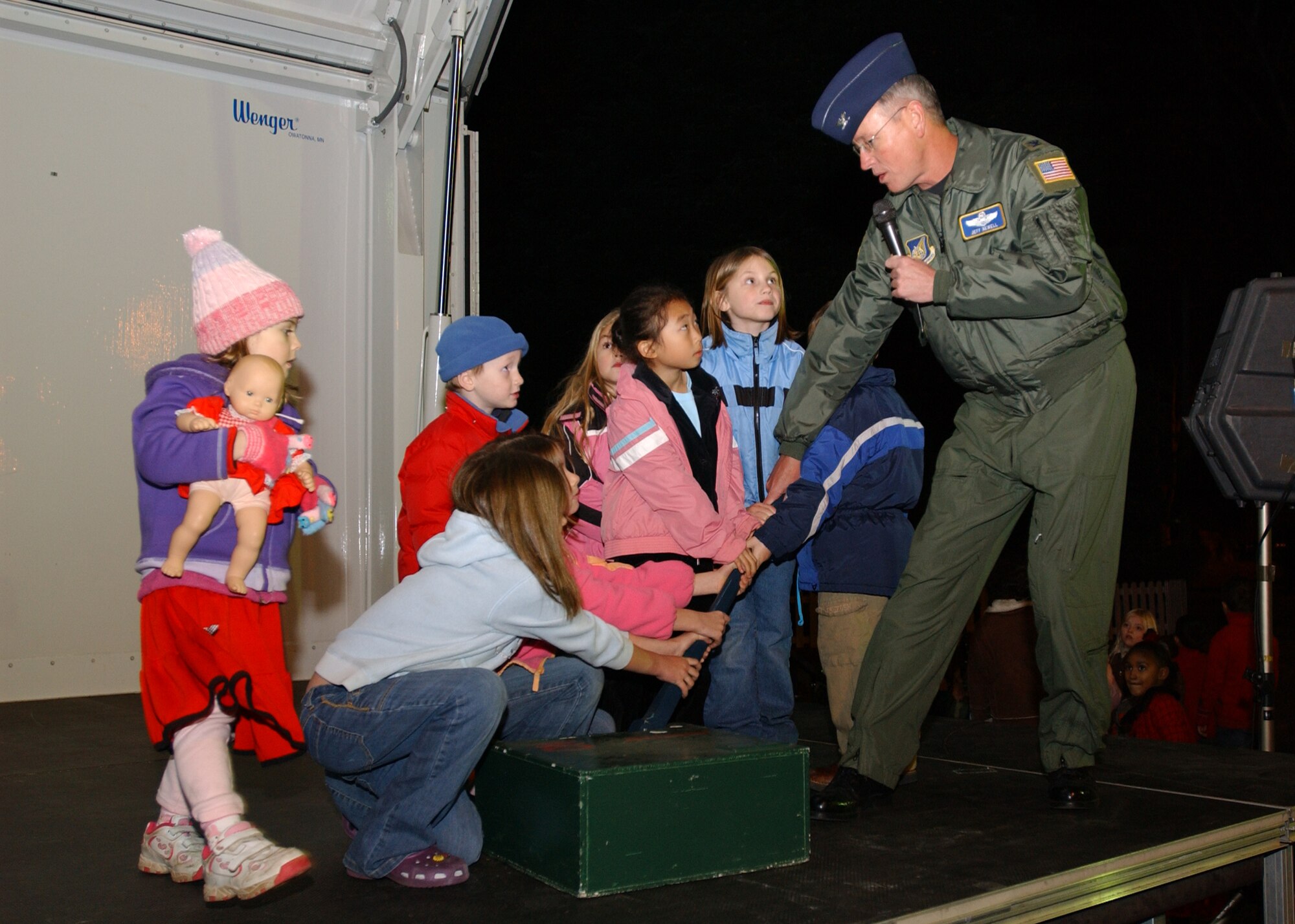 YOKOTA AIR BASE, Japan - Colonel Jeff Newell, commander of the 374th Airlift Wing, and a number of children prepare to pull the lever to light the Yokota Christmas Tree on December 6, 2007.  This was part of the Christmas Tree Lighting ceremony that included singing from the Yokota Community Choir, songs performed by the Yokota Hand Bell Choir and a visit from Santa Claus. (U.S. Air Force photo by Airman First Class Jonathan Fowler)                               