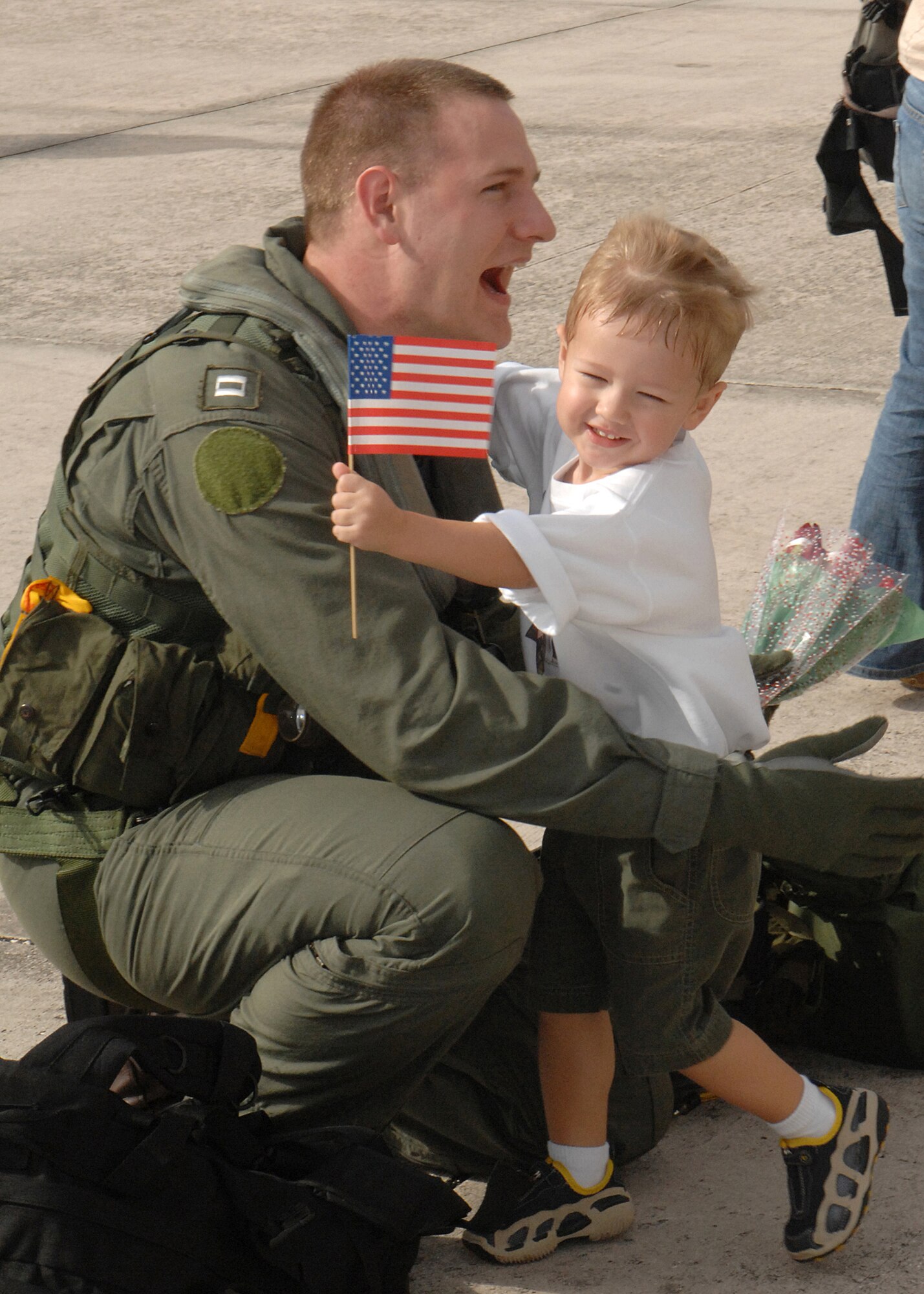 Lieutenant Heber Ashby gets a big welcome back hug from his two-year-old son, Hayden, during a homecoming celebration at Andersen Dec. 4. Members from HSC-25 were primarily based out of the USS Kitty Hawk Carrier in support of several exercises including Valient Shield from May to December. (U.S. Air Force photo/Senior Airman Sonya Padilla)