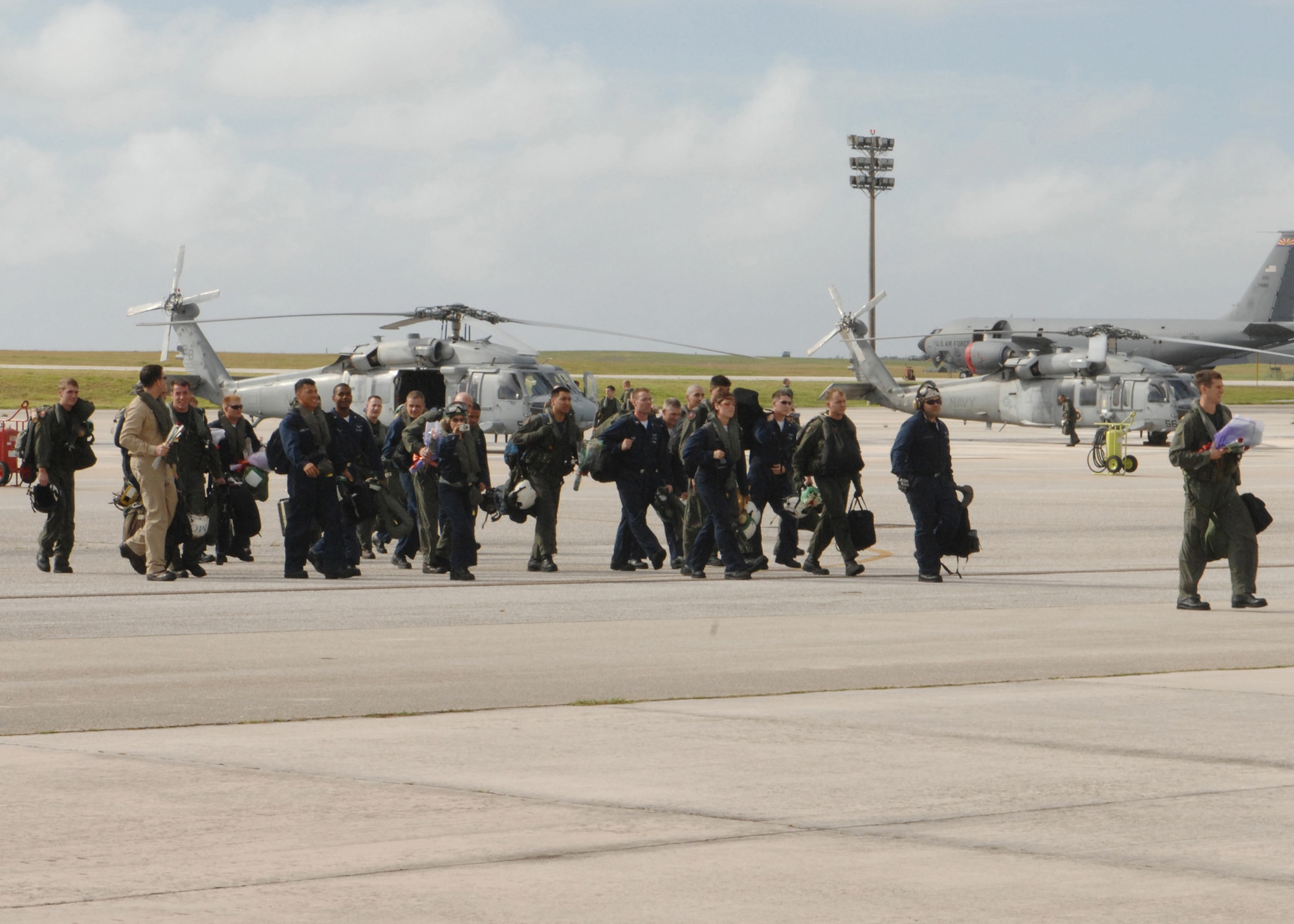 Deployed members of HSC-25 are welcomed back home by their loved ones during a homecoming celebration here at Andersen Dec. 4. Members were primarily based out of the USS Kitty Hawk Carrier in support of several exercises including Valient Shield from May to December. (U.S. Air Force photo/Senior Airman Sonya Padilla)