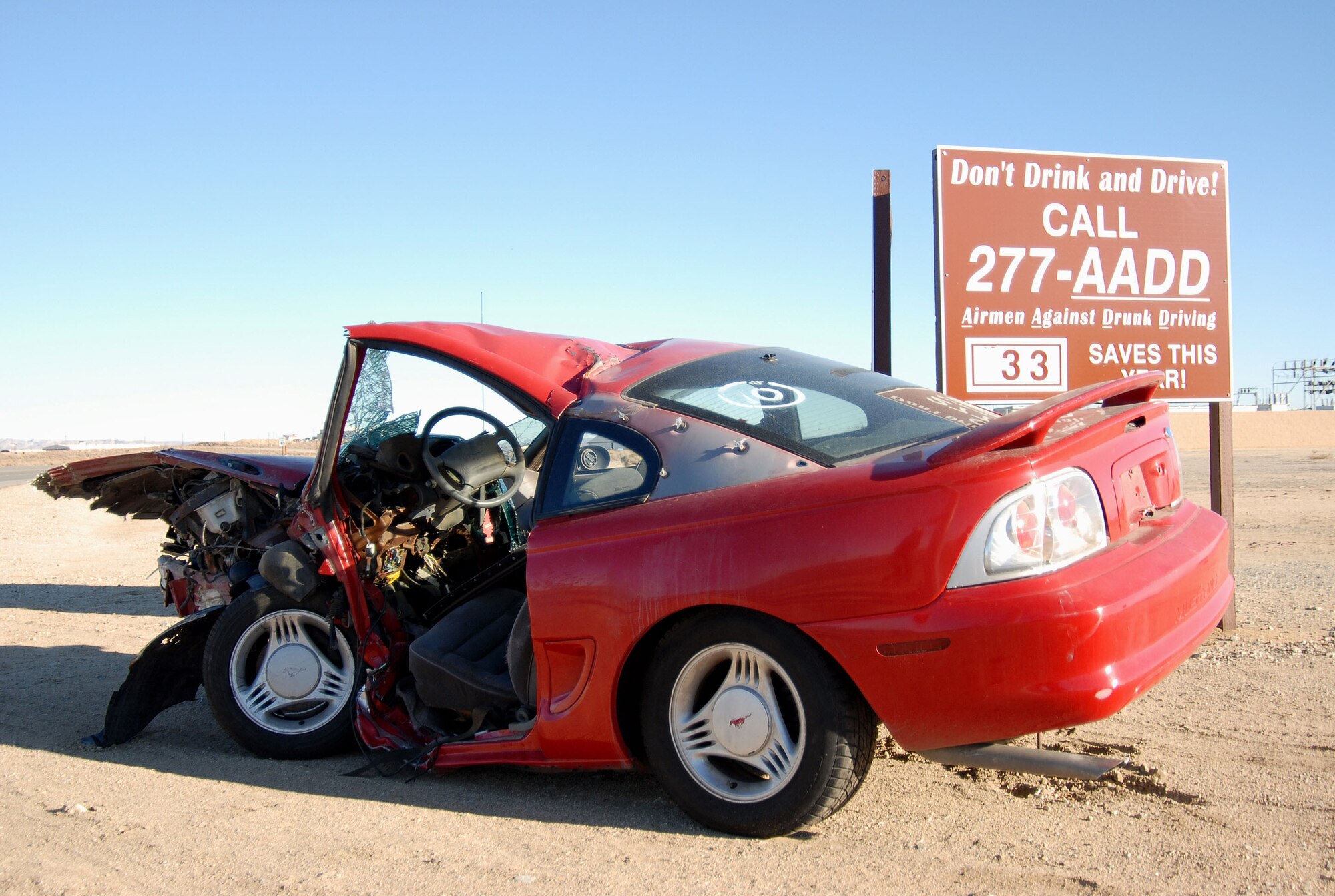 A wrecked car, displayed at the intersection of FitzGerald and Lancaster Boulevard, shows the potential impact of a DUI. The driver was driving under the influence of alcohol and hit a rail on a bridge. The 95th Security Forces Squadron and base programs such as National Drug and Drunk Driving Prevention month and Airmen Against Drunk Driving are working to reduce the numbers of DUIs through education and planning. (Photo by Senior Airman Jason Hernandez)