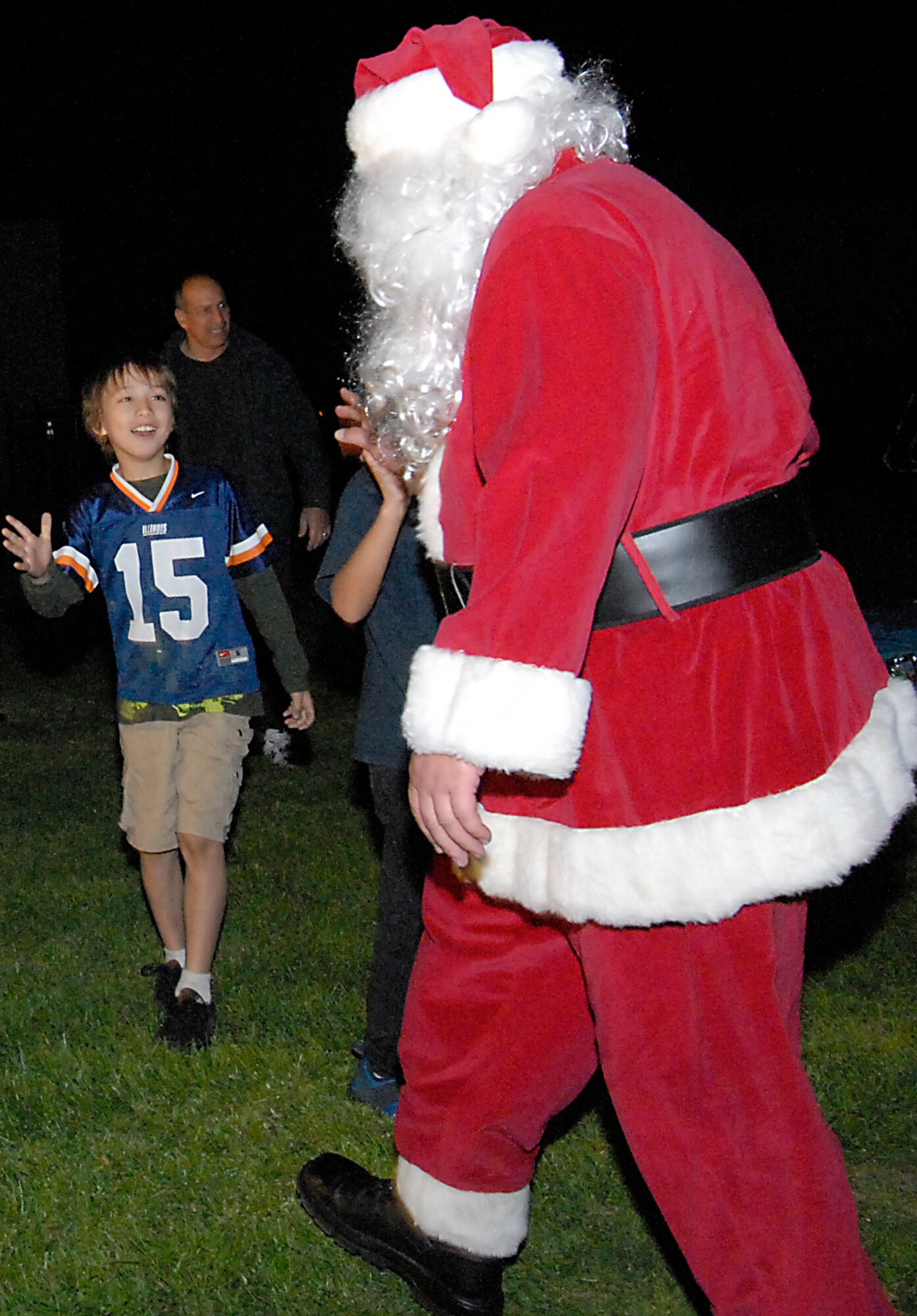 He knows who’s naughty or nice. Santa Claus is greeted by base children at the annual tree lighting ceremony held on Fort MacArthur, Nov. 29.  (Photo by Joe Juarez)