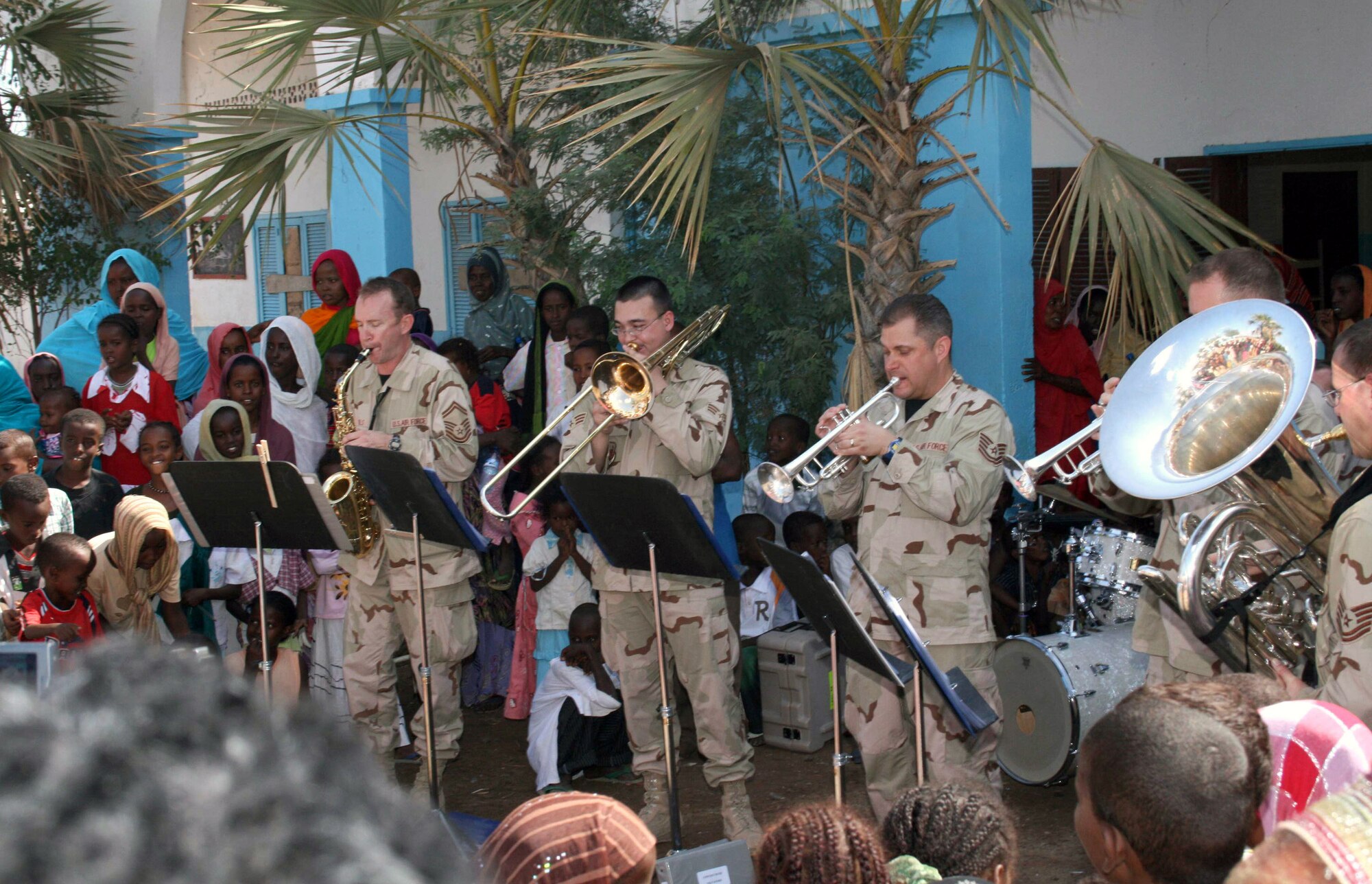United States Central Command Air Forces Expeditionary Band "Hot Brass," based at Wright-Patterson Air Force Base in Ohio, performs during an outreach engagement at a primary school in Douda, Djibouti, Dec. 6. Hot Brass members pictured, from left to right: Senior Master Sgt. Todd R. Nicholls, saxophone; Senior Airman Kaz Kruszewski, trombone; Senior Master Sgt. Eric A. Knorr, trumpet; Staff Sgt. Jason S. Plosch, trumpet; Tech. Sgt. John H. Rider, tuba. (U.S. Army photo/Army Sgt. Michelle Halpin)