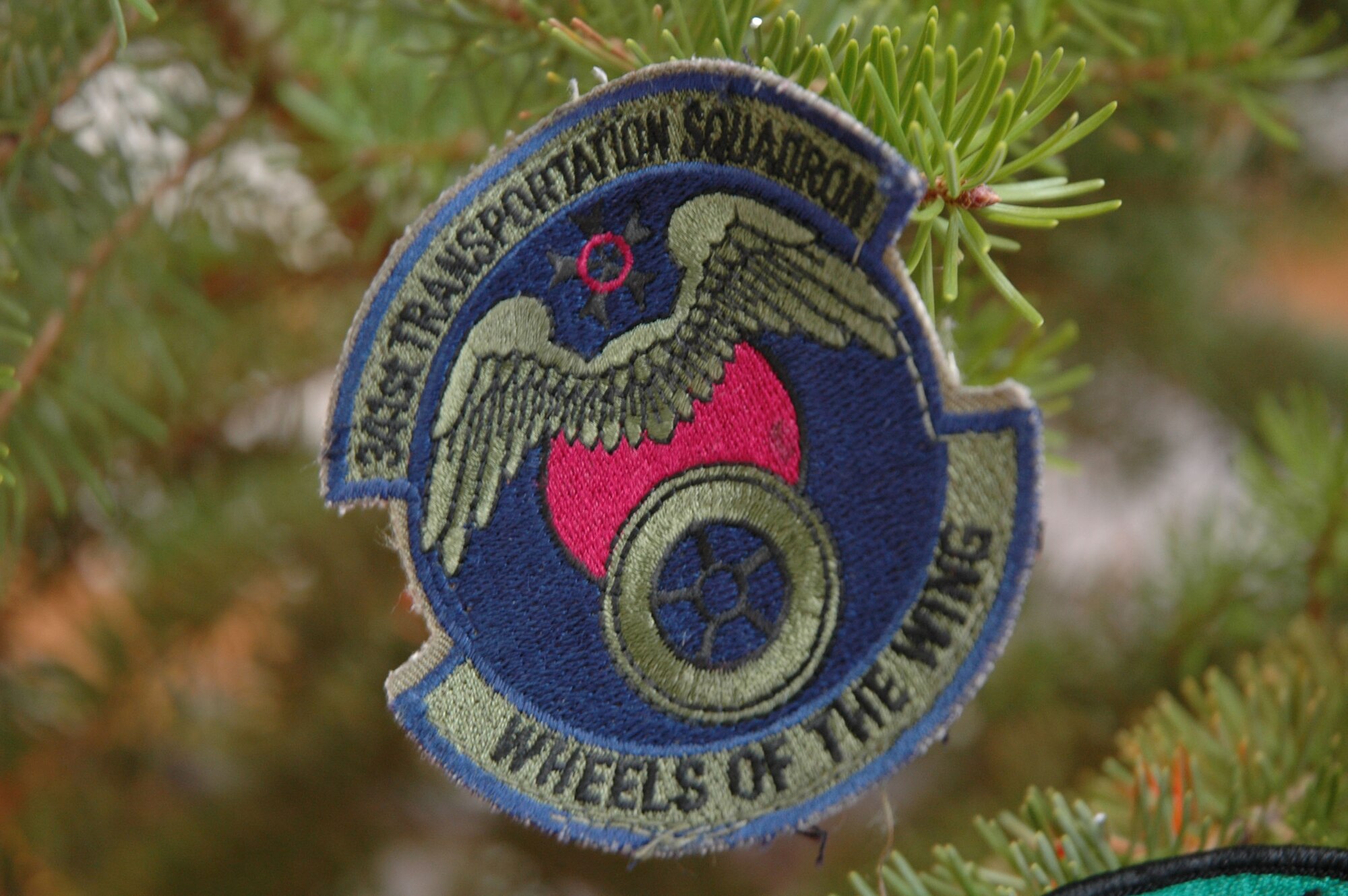 A unit patch from the 341st Transportation Squadron hangs on a Christmas tree in the hallway of the Base Exchange concessionaire area. Monica James, from Petals and Blooms, and Shelly Corr from Mr. Wise Cleaners decorated the tree with more than 50 patches as well as five yellow ribbons representing the five branches of the armed services, and three U.S. Air Force tapes from th ABU, BDU and DCU. Ms. Corr received the patches from Airmen who did not want their old patches when they had new ones sewn onto their uniforms. (U.S. Air Force photo/Airman 1st Class Dillon White)