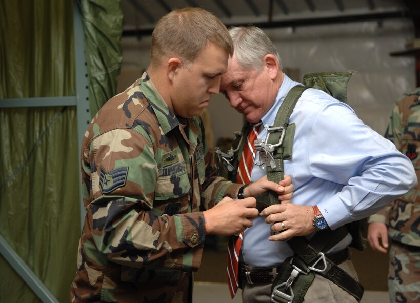 Staff Sgt. Michael Duperituis, 820th Security Forces Group survival equipment section NCO in-charge, adjusts the parachute harness of Bob Largent, Air Force Association chairman, in the group's parachute simulator facility here Dec 5.  Mr. Largent visited Moody to get a first-hand view of the base's diverse combat capabilities.  (U.S. Air Force photo by Senior Airman Elizabeth Rissmiller)