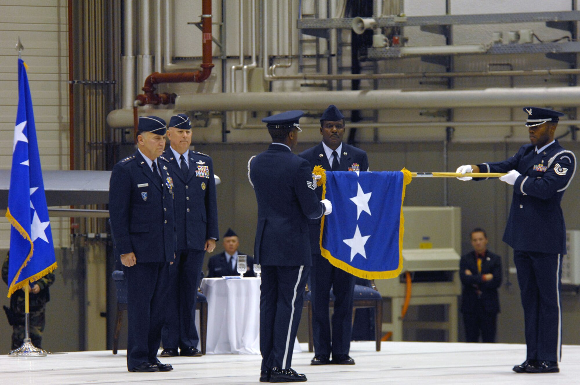 Air Force Chief of Staff Gen. T. Michael Moseley, U.S. Air Forces in Europe Commander, Gen. William T.  Hobbins, and Command Chief Master Sgt. Gary Coleman watch as the Ramstein Honor Guard retires General Hobbins' flag during his retirement ceremony Ramstein Air Base, Germany, Dec. 10.  (U.S. Air Force photo/Tech. Sgt. Kenneth Bellard)