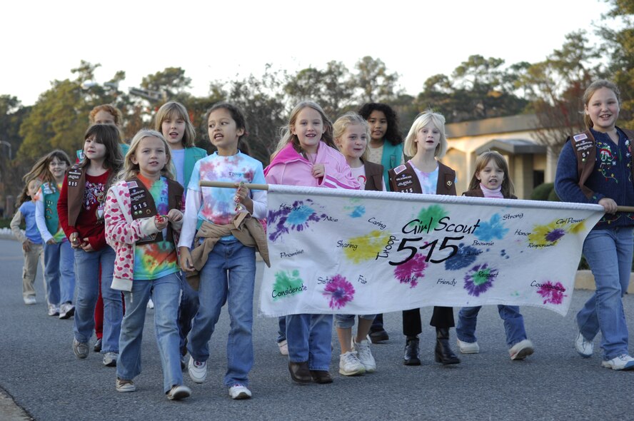 MOODY AIR FORCE BASE, Ga. -- Girl Scouts from Troop 515 sing Christmas carols while marching in the Moody Air Force Base Holiday Parade on Dec 7. Members of Team Moody and their dependents came out for the events which included a tree lighting ceremony and a visit form Mr. and Mrs. Claus. (U.S. Air Force photo by Senior Airman Elizabeth Rissmiller) 