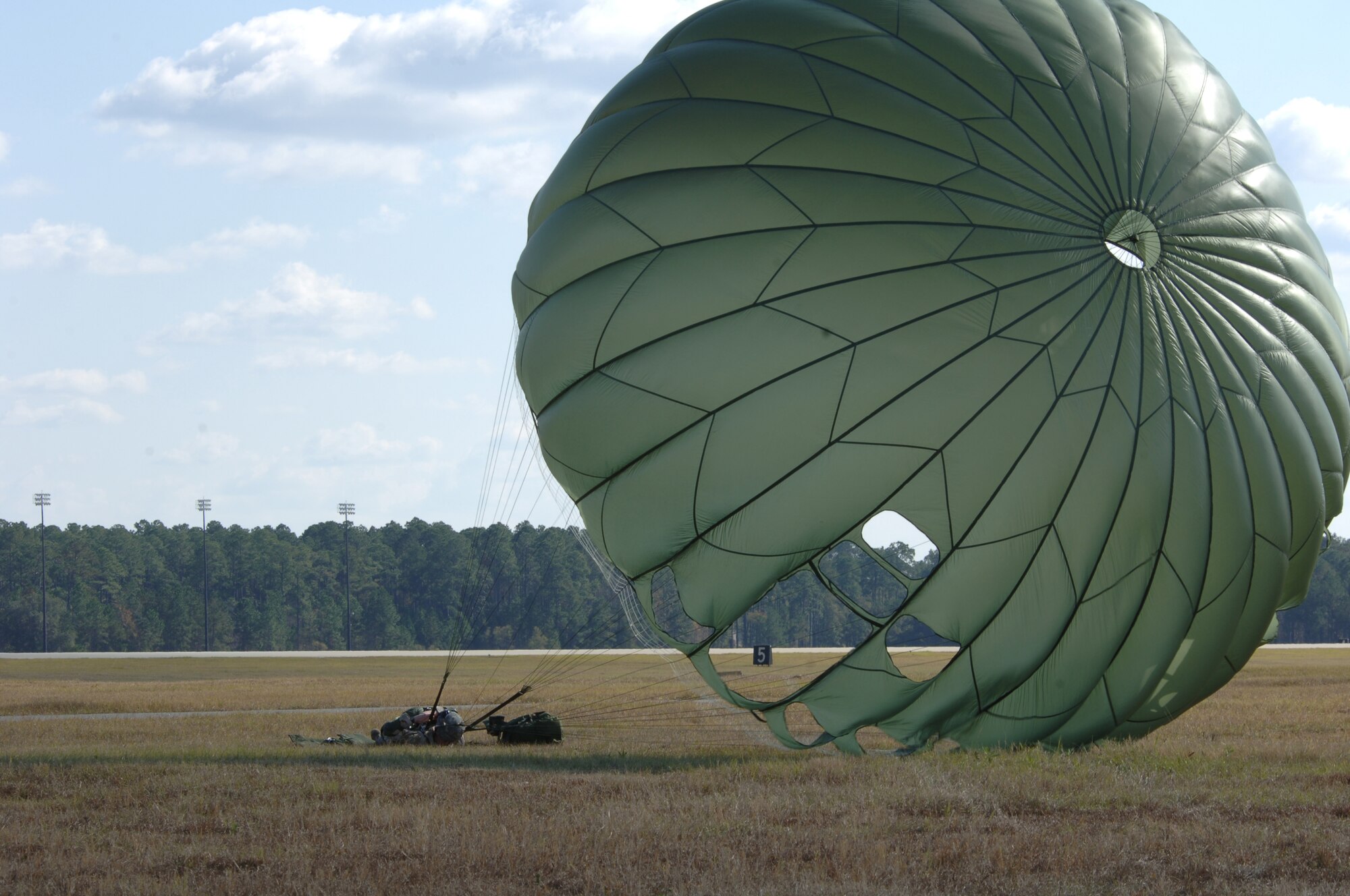 MOODY AIR FORCE BASE, Ga. -- Senior Airman Ryan Cushing, 824th Security Forces Squadron fire-team leader, recovers after landing following a jump from a HC-130P here Dec 9. Security Forces members train monthly to maintain proficiency. (U.S. Air Force photo by SrA Schelli Jones) 