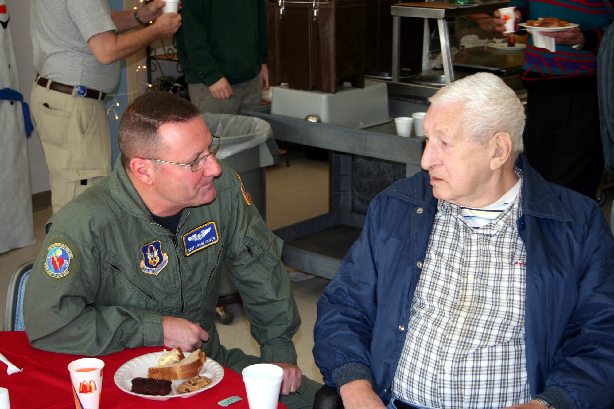 DAYTON, Ohio - Staff Sergeant Frank Oliver from the 445th Aeromedical Evacuation Squadron, talks with VA resident Alvin Copem at their annual Christmas Party.  The Air Force Sergeants Association has been hosting parties such as this one at the VA center for almost 20 years.  This was the 11th year the 445th Airlift Wing has helped with the party. (U.S. Air Force photo/Tech. Sgt. Charlie Miller)