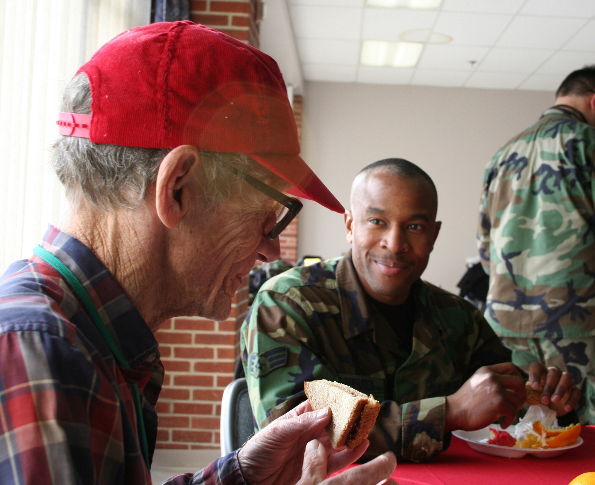 DAYTON, Ohio - Senior Airman Paul Humphries from the 445th Civil Engineer Squadron, talks with VA resident Wesley Schaffer at their annual Christmas Party.  The Air Force Sergeants Association has been hosting parties such as this one at the VA center for almost 20 years.  This was the 11th year the 445th Airlift Wing has helped with the party. (U.S. Air Force photo/Tech. Sgt. Charlie Miller)