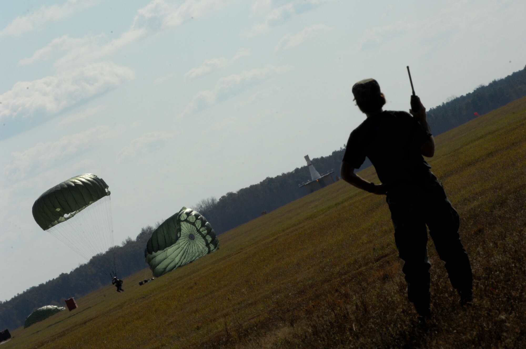 MOODY AIR FORCE BASE, Ga. — Tech. Sgt Barbara Daum, 822nd Security Forces Squadron independent duty medical technician, watches members of the 822nd SFS land during a proficiency training jump here Dec 9. Sergeant Daum was tasked with providing medical assistance in case of an emergency.  (U.S. Air Force photo by Senior Airman Angelita Lawrence)     