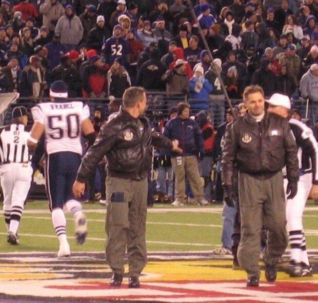 Maj. Ken Parsons, left, and Senior Master Sgt. James McKelligan, 337th Airlift Squadron, walk off the Baltimore Ravens football stadium Dec. 3 following the pre-game coin toss.