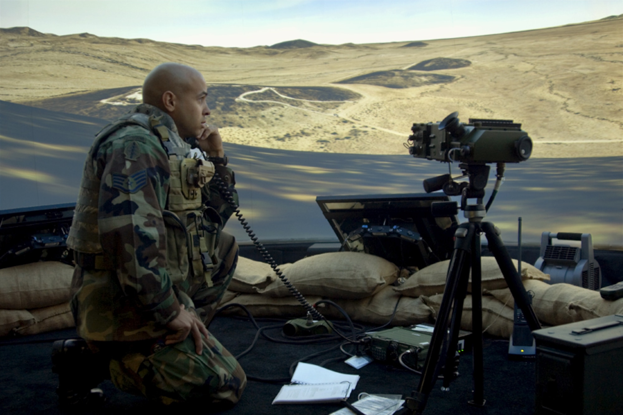 Inside the immersive virtual environment of the Joint Terminal Attack Control Training and Rehearsal System developed by the Air Force Research Laboratory’s Human Effectiveness Directorate, Warfighter Readiness Research Division, Staff Sergeant Dennis Krouse of the 9th Air Support Operations Squadron calls for F-16 close air support on enemy positions. (Photo by Gina Cinardo AFRL/RHA)