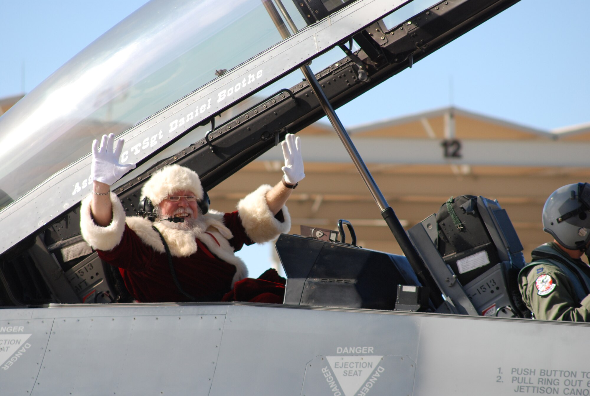 Santa arrived in the backseat of a 457th Fighter Squadron hometown-built F-16 recently. Jolly old Saint Nick, known the rest of the year as Dr. Don Shelton, member of the Fort Worth Air Power Council, visited children and 301st Fighter Wing families by handing out presents during the December Unit Training Assembly. This marks the third year Santa has arrived in high-tech Fighting Falcon style to the Naval Air Station Joint Reserve Base Fort Worth, Texas. (U.S. Air Force Photo/Staff Sgt. Kristin Mack)