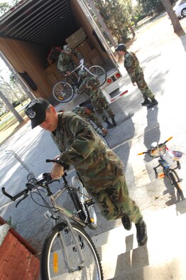 MOODY AIR FORCE BASE, Ga. — Maj. Timothy Porter, 23rd Wing chaplain, helps unload bikes and other packages to Lanier County Dec. 6 as part of the chapel's Adopt-a-Family program. For the past 30 years, the chapel has sponsored the event, which allows Team Moody members to give back to the local community. (U.S. Air Force photo by Senior Airman Angelita Lawrence) 
