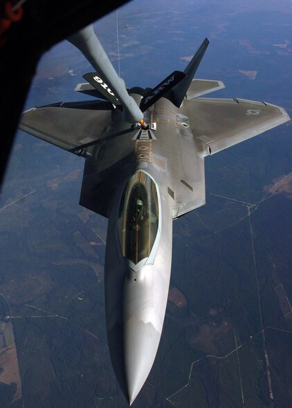 An F-22 Raptor receives fuel from a KC-135 Stratotanker during an air-to-air refueling training mission Dec. 4 over Eglin Air Force Base, Fla. The F-22 is from the 43rd Fighter Squadron at Tyndall AFB, Fla. The KC-135 is from the 916th Air Refueling Wing, an Air Force Reserve wing located at Seymour Johnson AFB, N.C.  (U.S. Air Force photo/Staff Sgt. Bryan Franks)