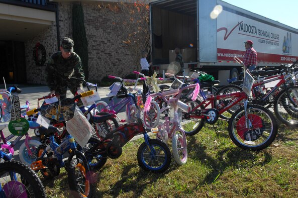 MOODY AIR FORCE BASE, Ga. – Airman 1st Class Deron Hix, 23rd Logistics Readiness Squadron fuel specialist, helps prepare bikes to be loaded at the Moody Chapel Dec 6 as part of the Adopt-a-Family program. Team Moody participates in the Adopt-a-Family program to give back to the local community. (U.S. Air Force photo by Senior Airman Angelita Lawrence) 
