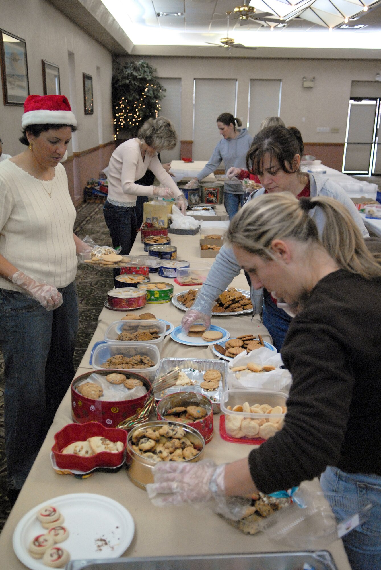 Volunteers from around Luke make cookie baskets for Airmen living in the dorms. Donations from members of the Luke community and local area totalled more than 12,000 cookies, making 647 cookie baskets. Christmas cards donated from local schools, boy scouts, girl scouts and church youth groups are also attached to the baskets. (photo by Airman 1st Class C.J. Hatch)
