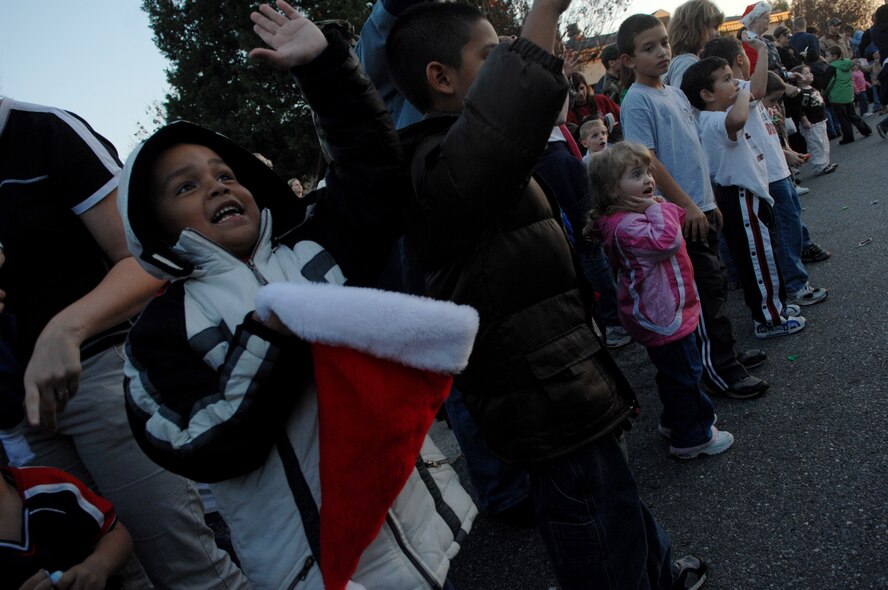 MOODY AIR FORCE BASE, Ga. --  Children wave to Santa Claus at the base Christmas parade Nov. 7. The evening also included a tree lighting ceremony and a snow field. (U.S. Air Force photo by Airman 1st Class Gina Chiaverotti)