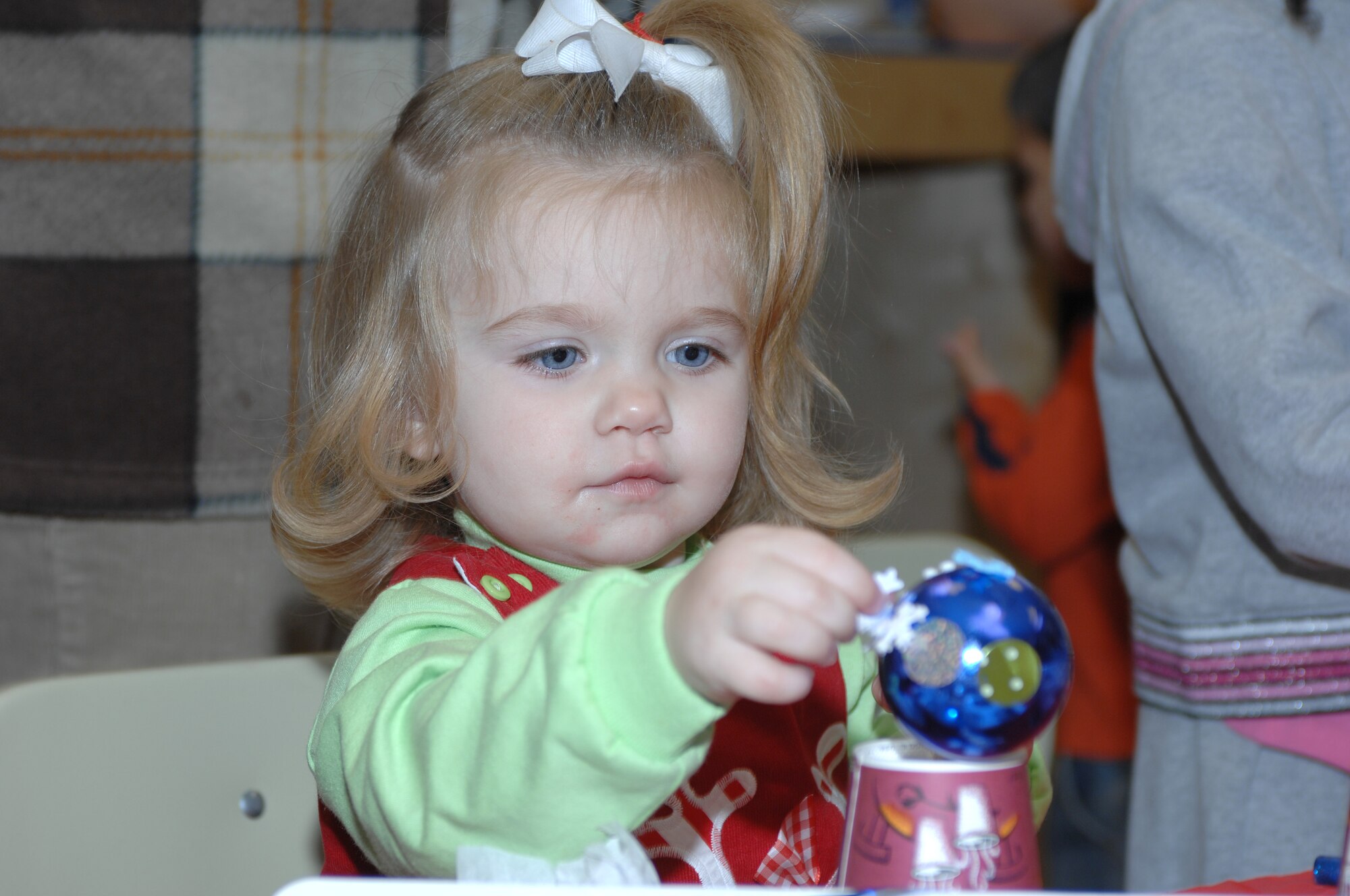 LANGLEY AIR FORCE BASE, Va. -- Caleigh Crisafulli, daughter of Maj. John Crisafulli, decorates an ornament during "Breakfast With Santa" Dec. 8. More than 800 people attended the event, which consisted of many activities including breakfast, writing letters to Santa and decorating ornaments. (U.S. Air Force photo/Staff Sgt. April Wickes)