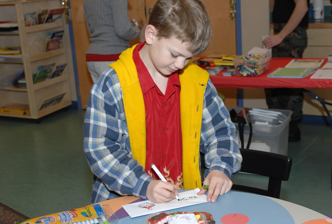 LANGLEY AIR FORCE BASE, Va. -- Joseph Miller, son or retired Petty Officer 1st Class Scott Miller, completes his letter to Santa during "Breakfast With Santa" Dec.8. More than 800 people attended the event, which consisted of many activities including breakfast, writing letters to Santa and decorating ornaments. (U.S. Air Force photo/Staff Sgt. April Wickes)