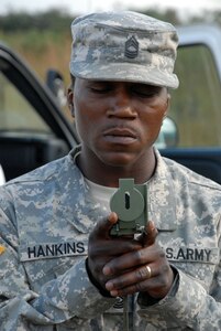 TAMARA DROP ZONE, Honduras - Army Master Sgt. Michael
Hankins, Joint Task Force-Bravo Army Forces, uses a compass to check wind
direction after a weather balloon was released.  Sergeant Hankins helped
setup the drop zone for U.S. and Honduran forces to jump from a CH-47
Chinook helicopter here Dec. 8. The jump was part of a graduation
requirement for the Honduran TESON unit.  TESON, which stands for Tropas
Especiales para Operaciones de Selva y Nocturnas, is an elite Honduran unit
akin to the U.S. Army Rangers.  (U.S. Air Force photo by Tech. Sgt. Sonny
Cohrs)
