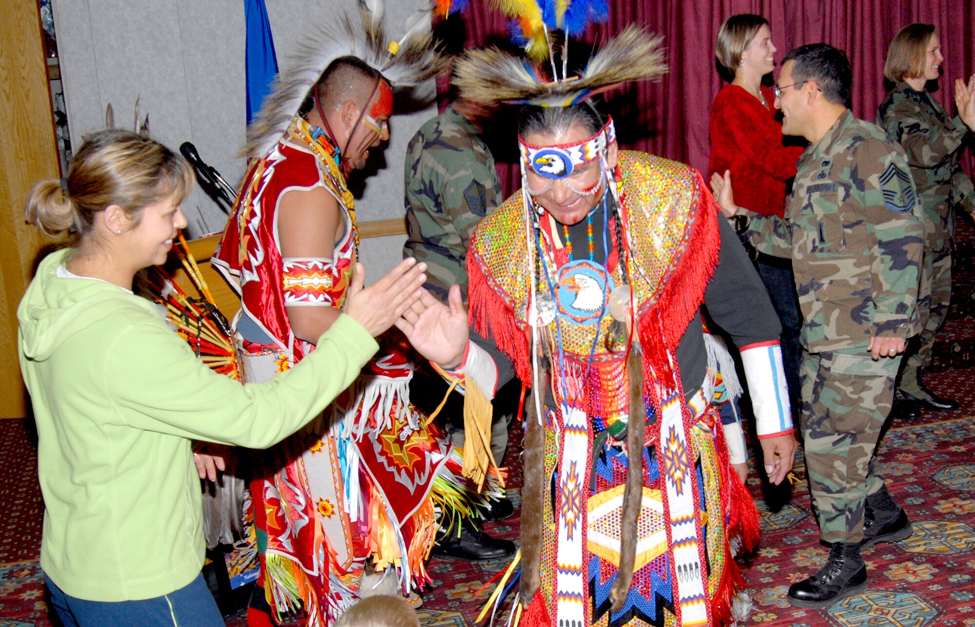 For the last dance of the Native American Pow-wow, Harvey Spoonhunter leads the audience in a circle dance where everyone greets each other. The pow-wow took place at the Trail’s End Club Nov. 27 and ended Native American Heritage Month (Photo by Berni Ernst).