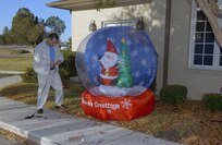 Richard Mcumber finishes up a snow globe outside Fisher House II on Dec. 4. Employees from local San Antonio Wal-Mart and Sam's Club stores spent the day decorating the Lackland Air Force Base and Fort Sam Houston Fisher Houses. In addition to the decorations provided by "Operation Deck the Walls," each Fisher House received $5,000 in gift cards to buy items for the houses. (USAF photo by Alan Boedeker)                               