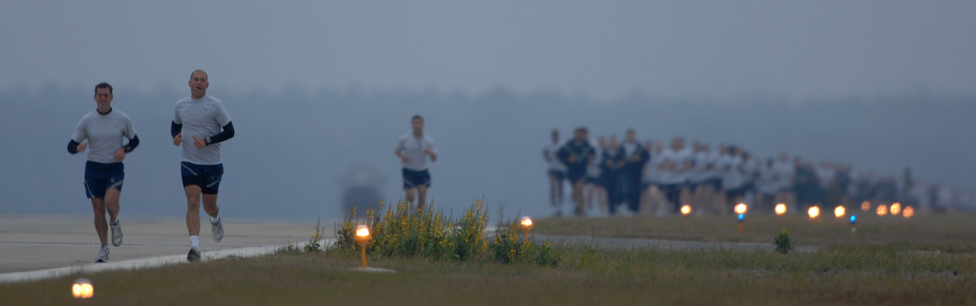 MOODY AIR FORCE BASE, Ga.--  Members of Team Moody run down base's main runway during the 5k wingman day run Nov. 7. Wingman day is held annually to reinforce the value of teamwork in every Airman's daily activities. (U.S. Air Force photo by Airman 1st Class Gina Chiaverotti)
