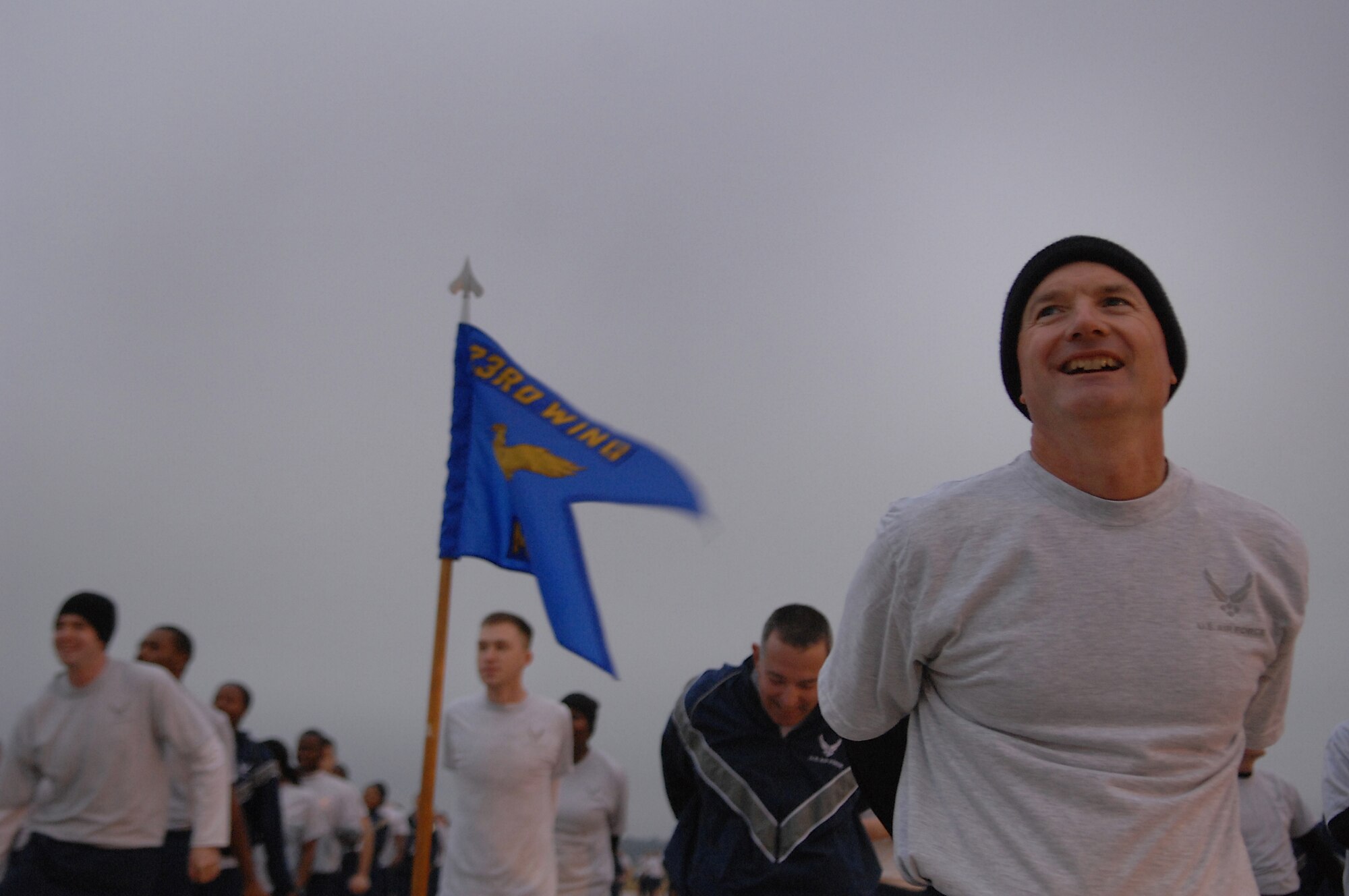 MOODY AIR FORCE BASE, Ga. -- Col. Les Martin, 23rd Mission Support Group commander, leads members of Team Moody during a warm up strech prior to the Wingman Day 5K run Dec. 7. Wingman day is held annually to reinforce the value of teamwork in every Airman's daily activities. (U.S. Air Force photo by Airman 1st Class Brittany Barker) 