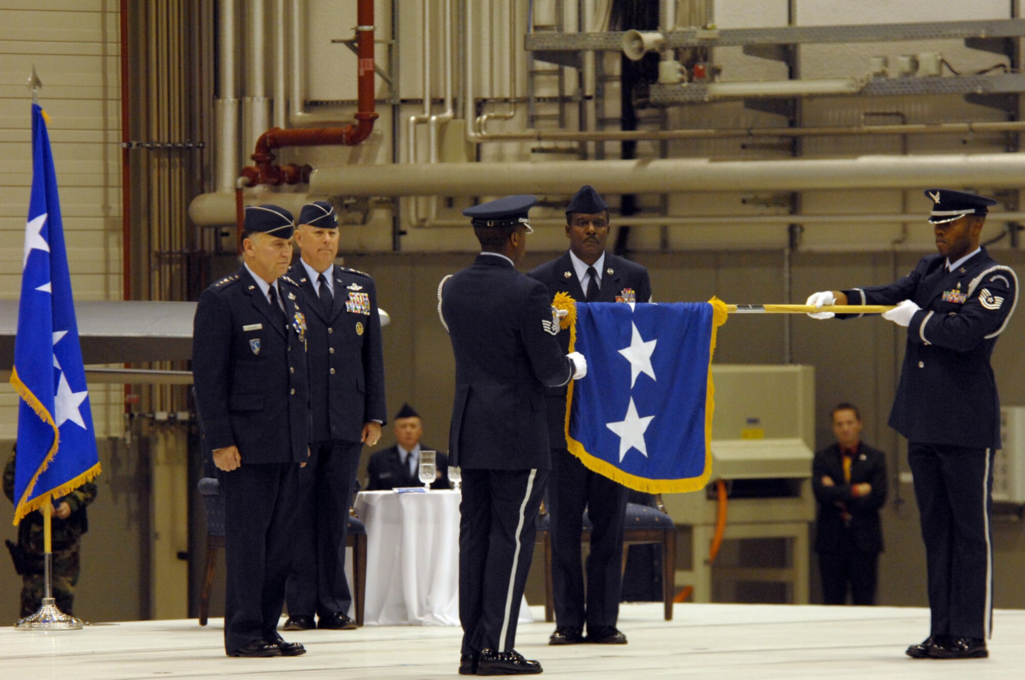 Air Force Chief of Staff Gen. T. Michael Moseley, U.S. Air Forces in Europe commander, Gen. William T.  Hobbins, and Command Chief Master Sgt. Gary Coleman watch as Ramstein Honor Guard retires Gen. Hobbins flag during Gen. Hobbins retirement ceremony Ramstein Air Base, Germany, Dec. 10.  (U.S. Air Force photo by TSgt Kenneth Bellard)(Released).