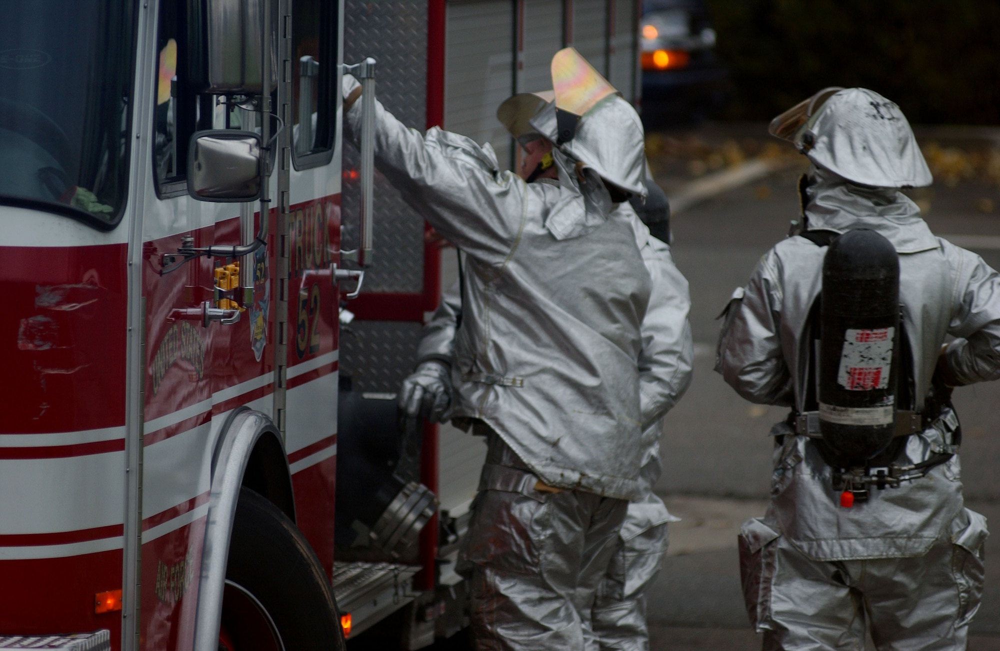 SPANGDAHLEM AIR BASE, Germany -- Senior Airman Corey Richards, 52nd Civil Engineering Squadron Fire Department, prepares to climb onto his rig to hand spools of hose to other members of the fire department during a simulated mass-casualty exercise held as part of a base-wide training week here. (U.S. Air Force photo/Senior Airman Matthew S. Bright) 