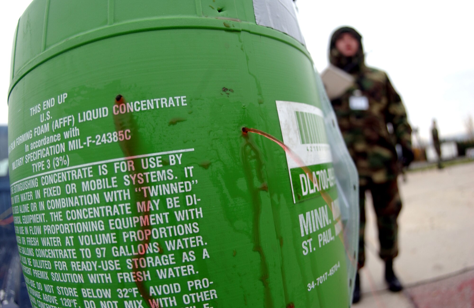 SPANGDAHLEM AIR BASE, Germany -- Following a simulated explosion, an unknown liquid flows from holes in a Hazardous Materials container during a mass-casualty exercise held as part of a base-wide training here. (U.S. Air Force photo/Senior Airman Matthew S. Bright) 
