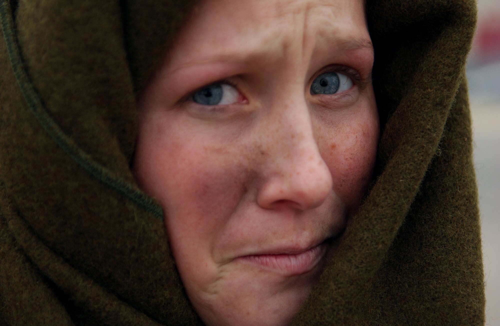 SPANGDAHLEM AIR BASE, Germany -- Braving the cold and biting wind, Airman 1st Class Blakley Engel, 52nd Dental Squadron, covers herself with a wool blanket while participating in a simulated mass-casualty exercise held as part of a base-wide training week here. (U.S. Air Force photo/Senior Airman Matthew S. Bright) 