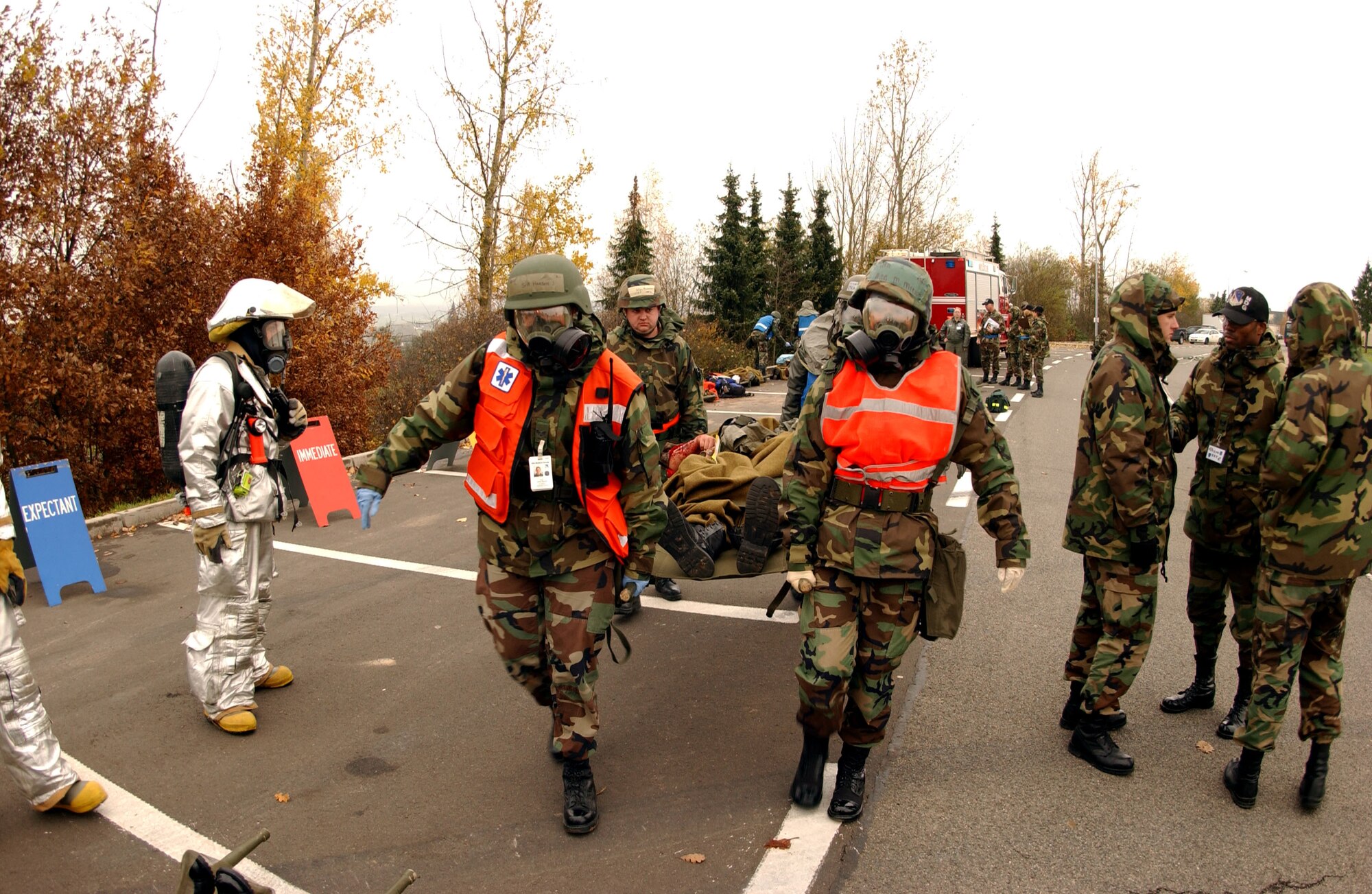 SPANGDAHLEM AIR BASE, Germany – (Left to right) Senior Airman Jessica McCracken, 52nd Medical Operations Squadron ambulance service, Master Sgt. David Anderson, 52nd Medical Support Squadron, and Airman 1st Class Macey Miller, 52nd Aerospace Medicine Squadron Flight Medicine Clinic, carry a litter holding an simulated injured Airman to an awaiting ambulance during a mass-casualty exercise held as part of a base-wide training week here. (U.S. Air Force photo/Senior Airman Matthew S. Bright) 