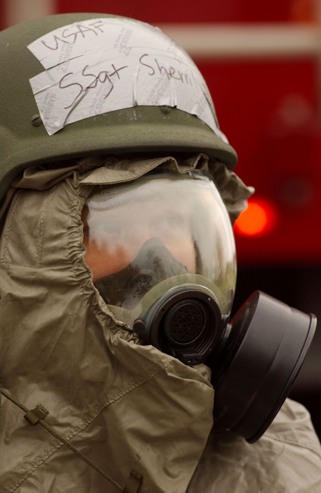 SPANGDAHLEM AIR BASE, Germany -- Staff Sgt. Sherril Erickson, 52nd Aerospace Medicine Squadron dons her chemical gear while awaiting direction from on-site commanders during a mass-casualty exercise held as part of a base-wide training week at here. (U.S. Air Force photo/Senior Airman Matthew S. Bright) 