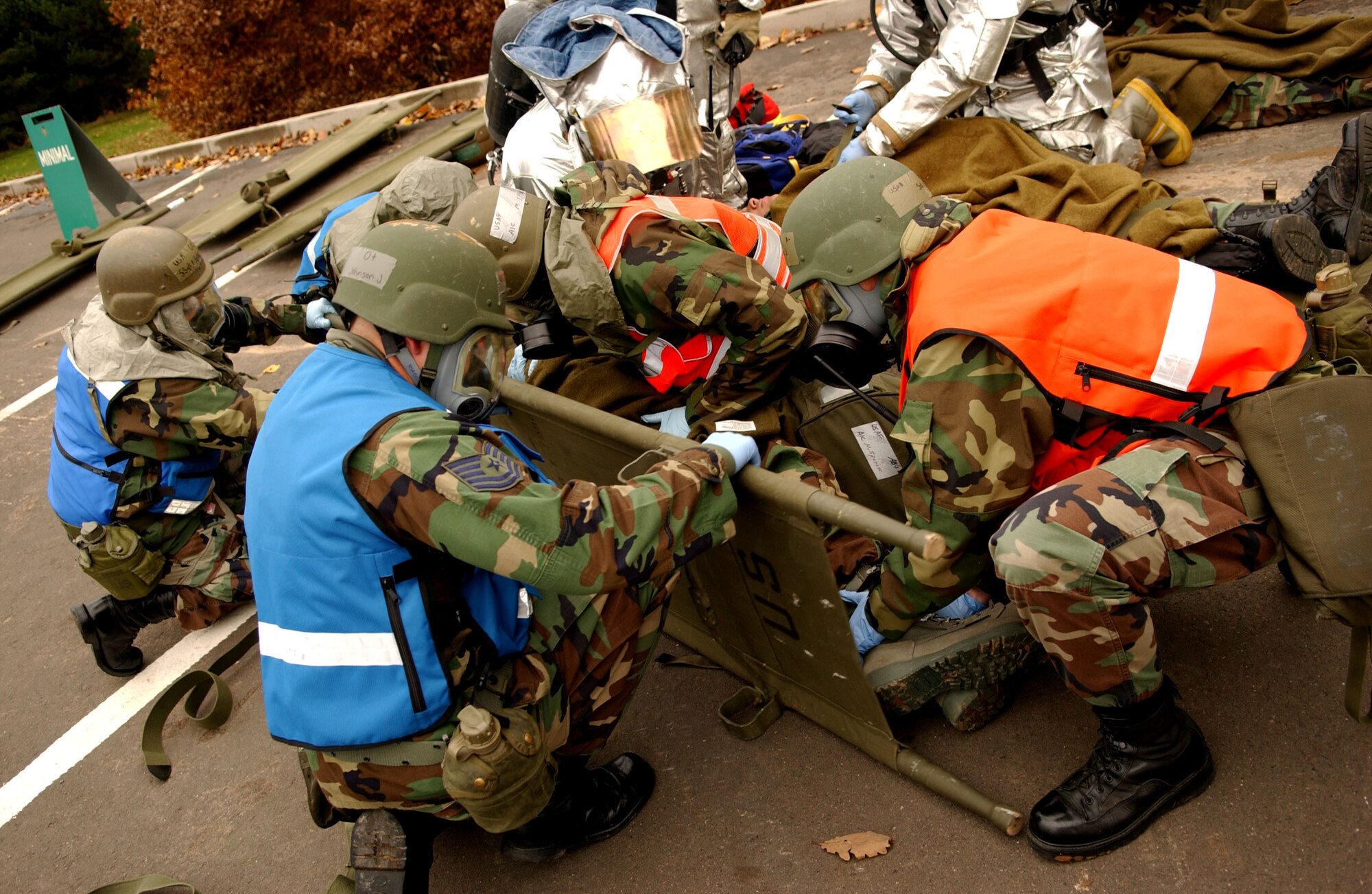 SPANGDAHLEM AIR BASE, Germany – Tech. Sgt. Jeffrey Johnson, 52nd Medical Operations Squadron ambulance service, holds the litter as Airmen 1st Class Mark Spencer and Macey Miller, both from the 52nd Aeromedical Squadron Flight Medicine Clinic, prepare a casualty for transport during a simulated mass-casualty exercise held as part of a base-wide training week here. (U.S. Air Force photo/Senior Airman Matthew S. Bright) 