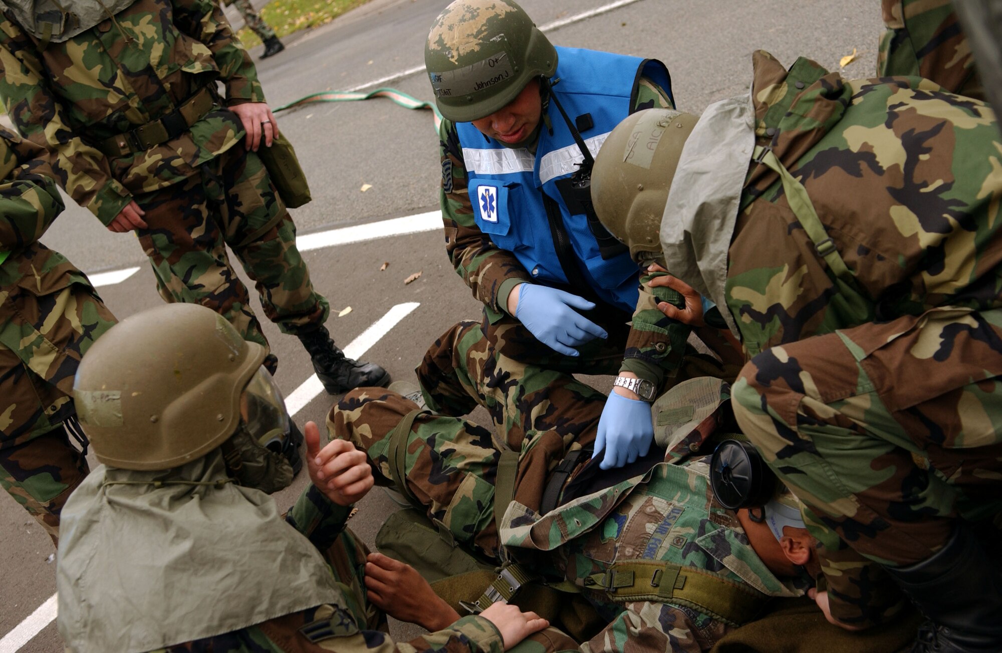 SPANGDAHLEM AIR BASE, Germany – Tech. Sgt. Jeffrey Johnson, 52nd Medical Operations Squadron ambulance service, examines the simulated stomach wound of an Airman while participating in a mass-casualty exercise held as part of a base-wide training week here. (U.S. Air Force photo/Senior Airman Matthew S. Bright) 