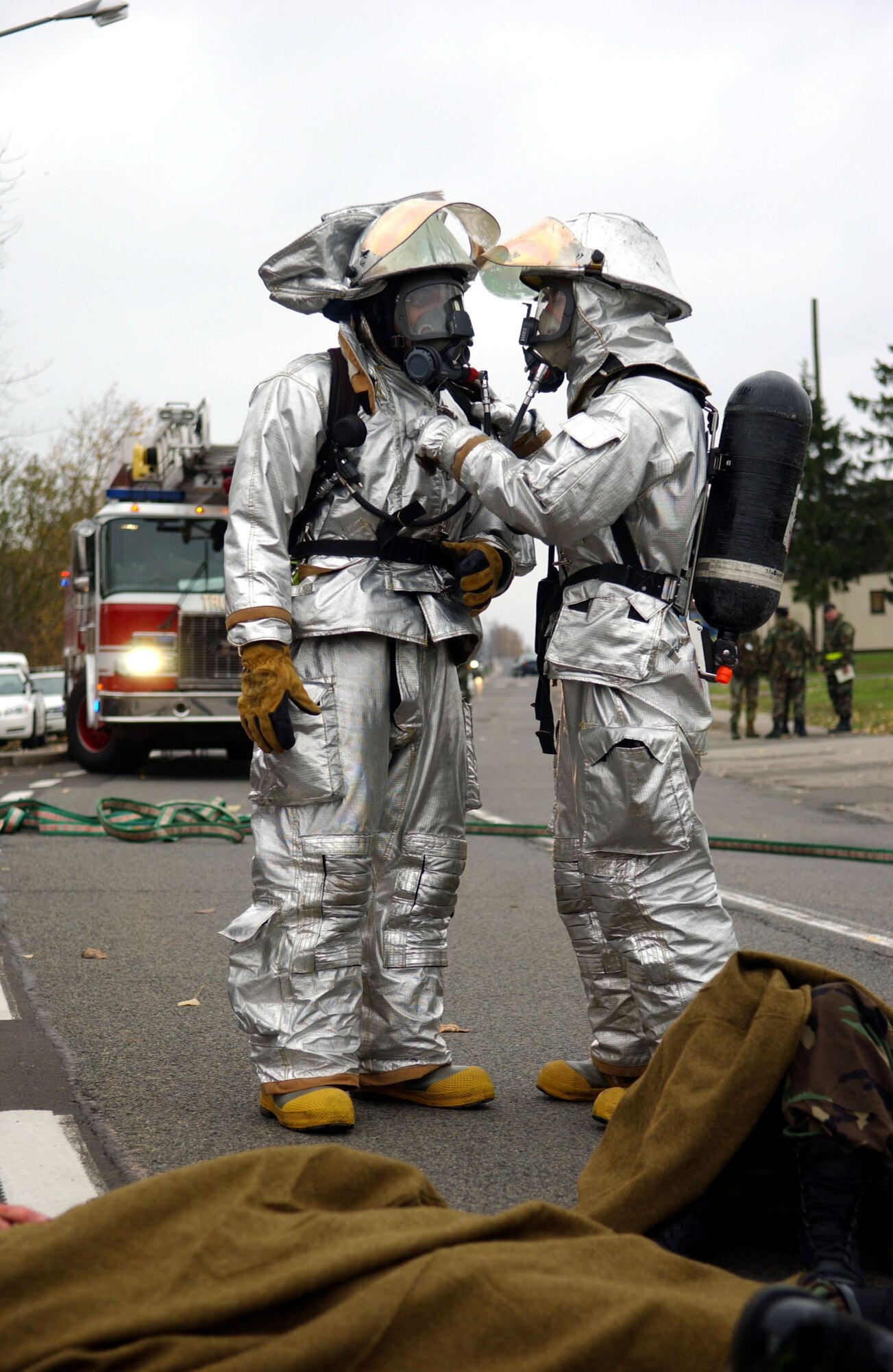 SPANGDAHLEM AIR BASE, Germany -- Airman 1st Class Timothy Sherrod and Staff Sgt. Richard Durstine, both from the 52nd Civil Engineering Squadron Fire Department, discuss the treatment and evacuation of personnel during a simulated mass-casualty exercise held as part of a base-wide training week here. (U.S. Air Force photo/Senior Airman Matthew S. Bright) 