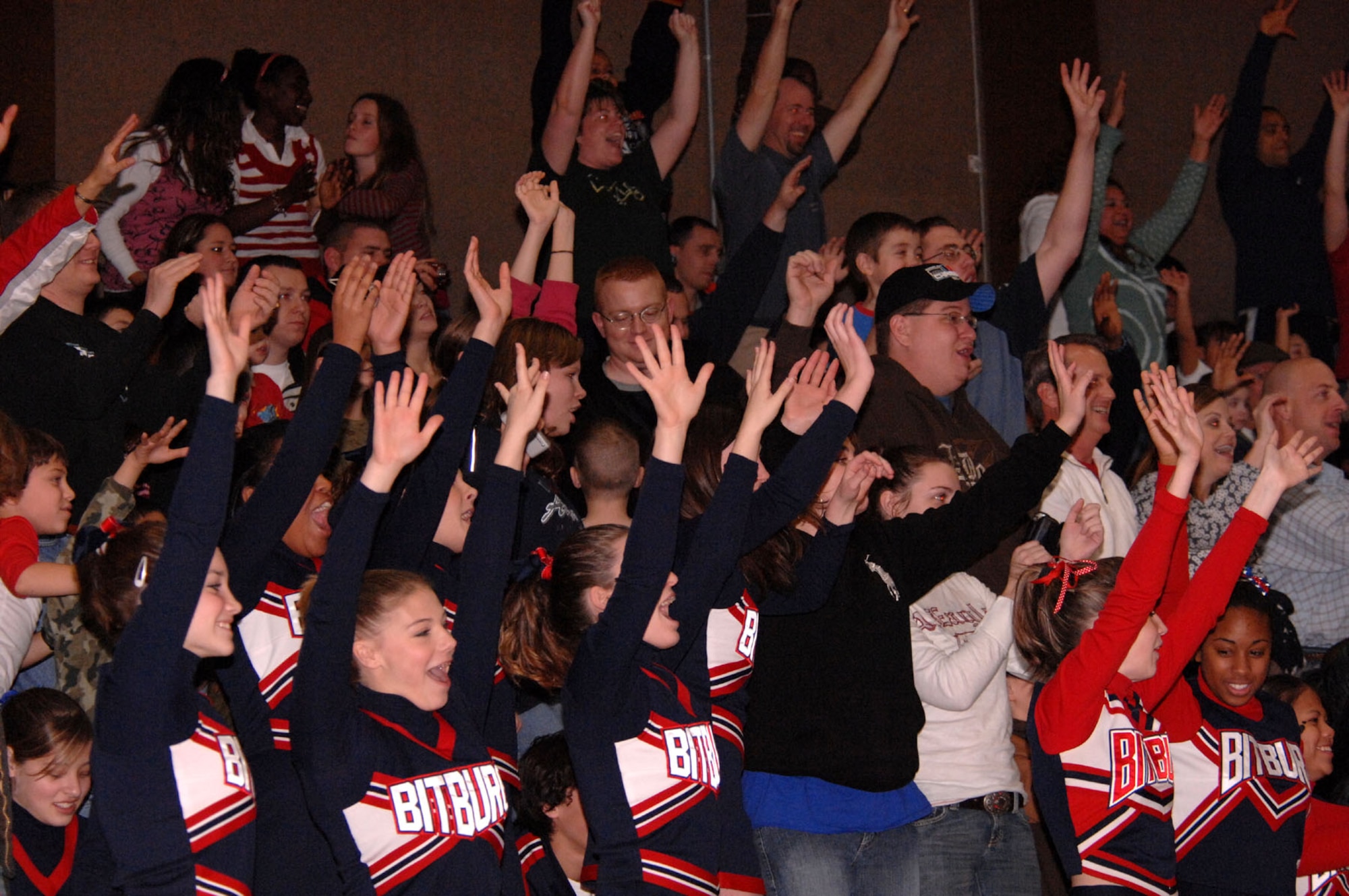 SPANGDAHLEM AIR BASE, Germany – Members of the crowd and Bitburg High School cheerleading squad cheer on members of the Harlem Globetrotters during their performance the Skelton Memorial Fitness Center here Dec. 6. The Globetrotters, an American icon, are touring U.S. Army and Air Force installations throughout Europe as part of their "Magic As Ever" 2008 world tour. The Globetrotters, synonymous with family entertainment and great basketball skills.(U.S. Air Force photo/Senior Airman Kristin Ruleau)