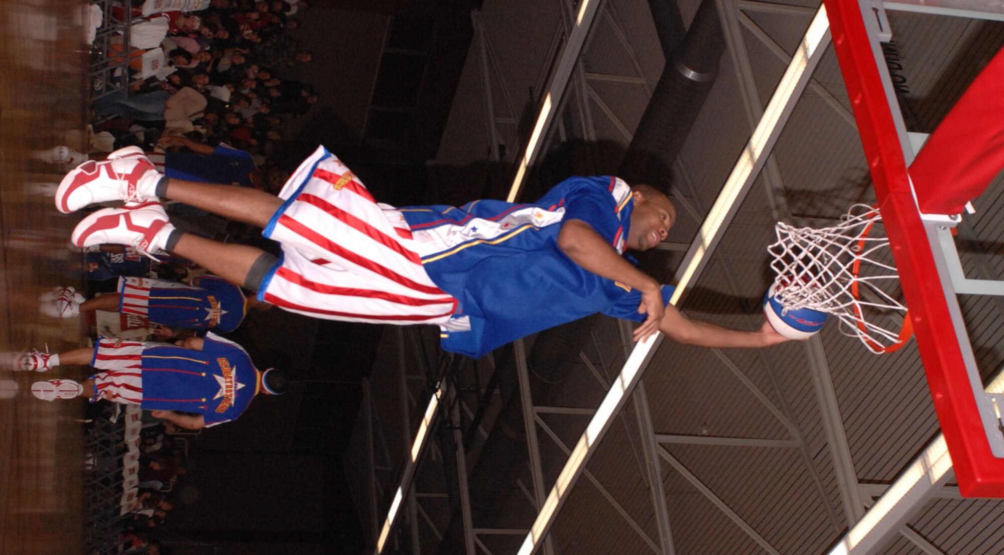 SPANGDAHLEM AIR BASE, Germany -- A member of the Harlem Globetrotters throws down a monster dunk during the game at the Skelton Memorial Fitness Center here Dec. 6. The Globetrotters are touring U.S. Army and Air Force installations throughout Europe as part of their "Magic As Ever" 2008 world tour (U.S. Air Force photo/Senior Airman Kristin Ruleau)