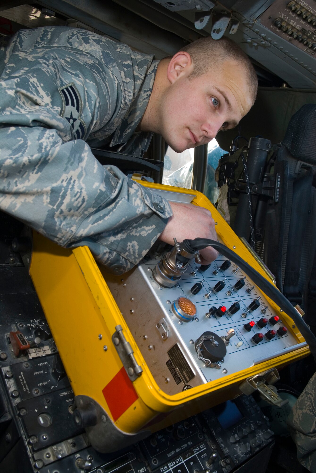 BALAD AIR BASE, Iraq -- Senior Airman Jeffrey Singer, a 64th Expeditionary Helicopter Maintenance Unit instrumentation and flight control systems specialist, makes adjustments to a Vertical Instrument Display System tester while trouble shooting the cockpit of HH-60 Pave Hawk here, Dec. 8. Tests are done to ensure the aircraft functions properly.  The 64th EHMU maintains the Pave Hawks in support of the 64th Expeditionary Rescue Squadron. Airman Singer is deployed from Nellis Air Force Base, Nev.  (U.S. Air Force photo/Staff Sgt. Joshua Garcia)