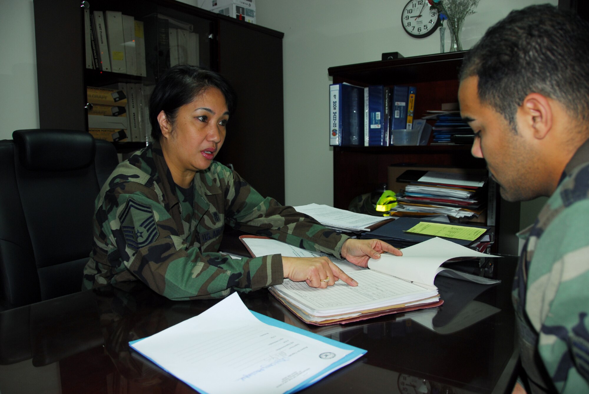 OSAN AIR BASE, Republic of Korea --  Senior Master Sgt. Theresa Chan, superintendant of the 51st Medical Operations Squadron, reviews training records with an Airman recently. Sergeant Chan was selected as Pacific Air Forces' Aerospace Medical Services Functional Manager of the Year. (U.S. Air Force photo by Staff Sgt. Ronnie Hill) 