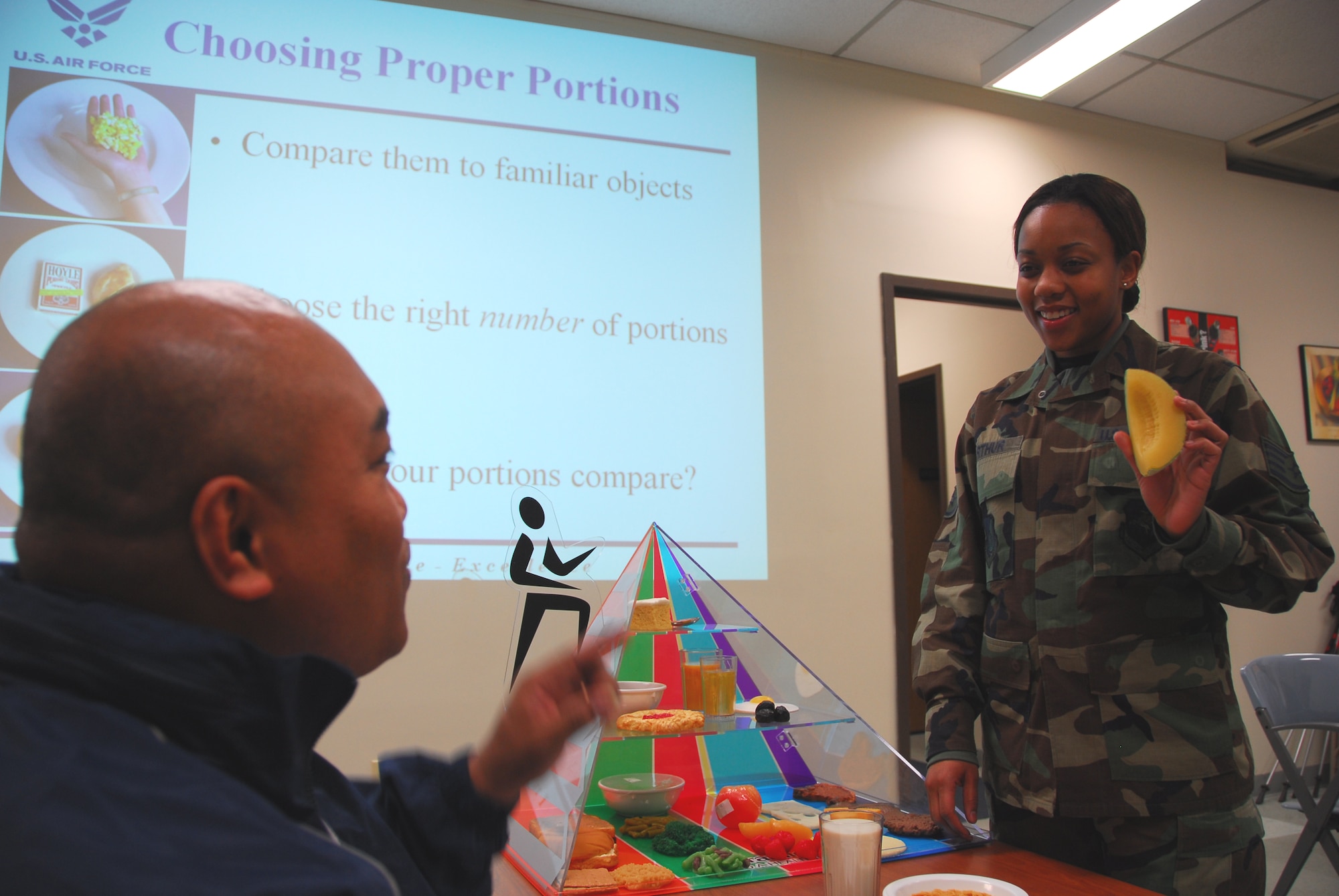 OSAN AIR BASE, Republic of Korea --  Staff Sgt. Vanessa Arthur, stationed here with the 51st Aerospace Medicine Squadron, shows proper portions during a Healthy Living class here. Sergeant Arthur receied the Pacific Air Forces' Chief Harvey A. Cain Award as a dietary therapy Airman. (U.S. Air Force photo by Staff Sgt. Ronnie Hill) 
