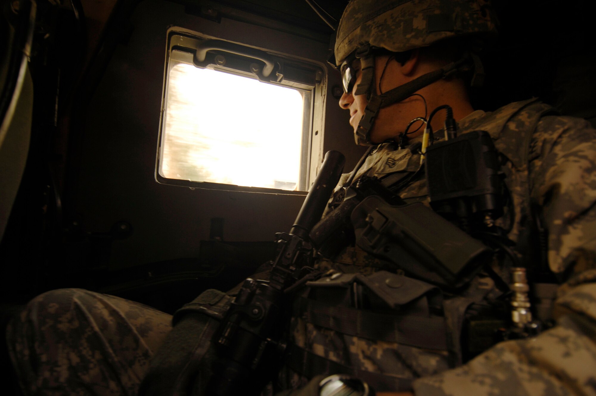 NANGARHAR PROVINCE, Afghanistan - Senior Airman Robert Shuman, Nangarhar Provincial Reconstruction Team, observes activity outside his High Mobility Multipurpose Wheeled Vehicle during a canal assessment mission Nov. 10, 2007. 

The Nangarhar PRT is a joint team of Airman, Soldiers, and representatives from the U.S. Department of State, the U.S. Agency for International Development, and the U.S. Department of Agriculture.  The Nangarhar PRT is a joint team of Airman, Soldiers, and representatives from the U.S. Department of State, U.S. Agency for International Development and the U.S. Department of Agriculture.  The team is responsible for helping the Government of the Islamic Republic of Afghanistan improve security, governance and promote reconstruction in Nangarhar Province.  The PRT assesses community needs and then builds schools, government centers, roads, medical capability and basic infrastructure throughout Nangarhar Province. (U.S. Air Force photo by Staff Sgt. Joshua T. Jasper)

