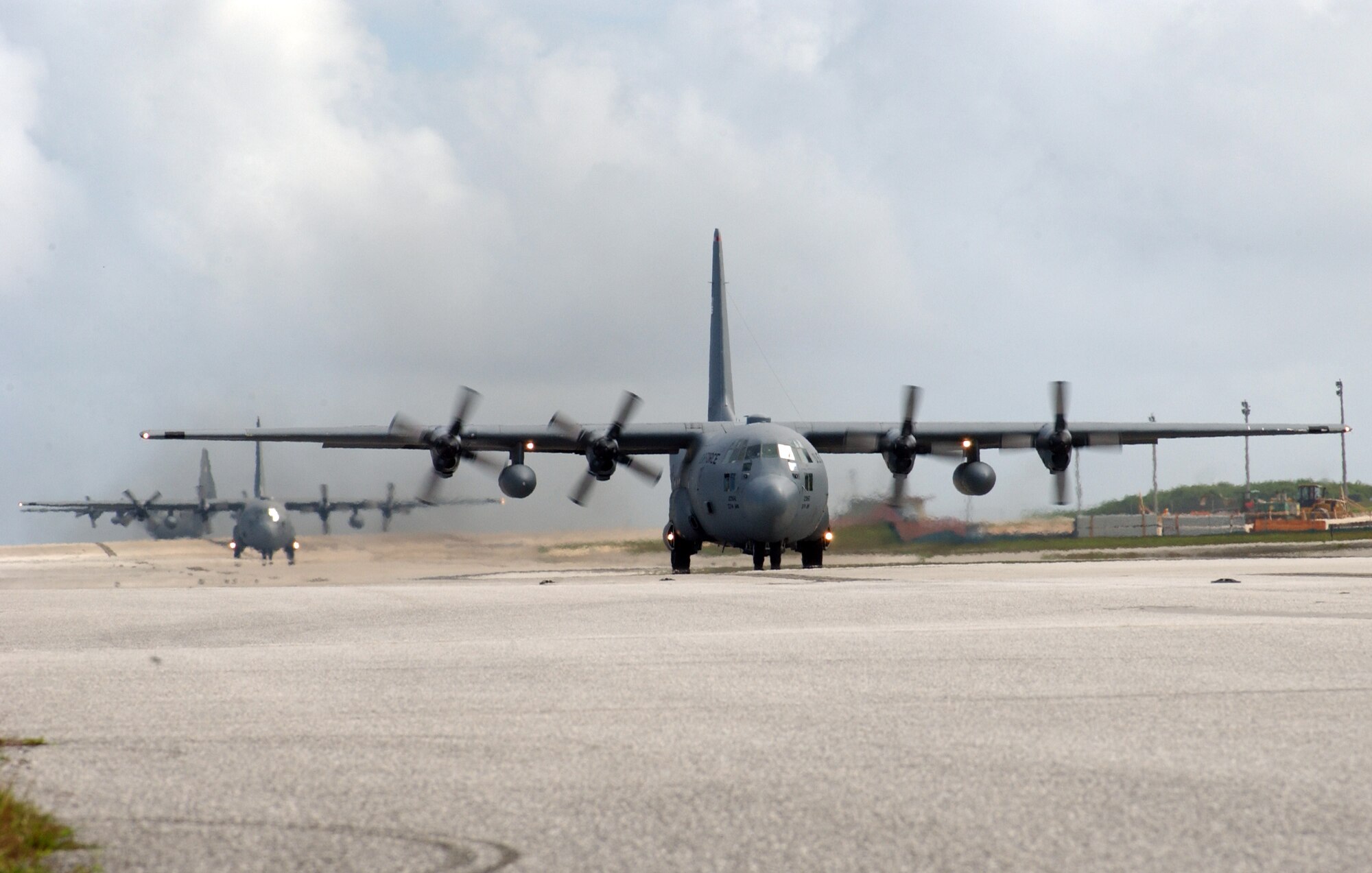 C-130s from the 374th Air Wing, Yokota Air Base, Japan, assemble on Andersen’s airfield in preparation for an early morning take off. These flights are designed to allow the Airmen to practice the aerial maneuvers they will need to accomplish their next mission, Operation Christmas Drop. This annual event allows the Air Force to use its aerial delivery platforms, such as the C-130 Hercules, to deliver holiday cheer to sparsely populated islands in Micronesia. Operation Christmas Drop is scheduled for December 14th – 17th. (Air Fore photo/Senior Airman Brian Kimball)
